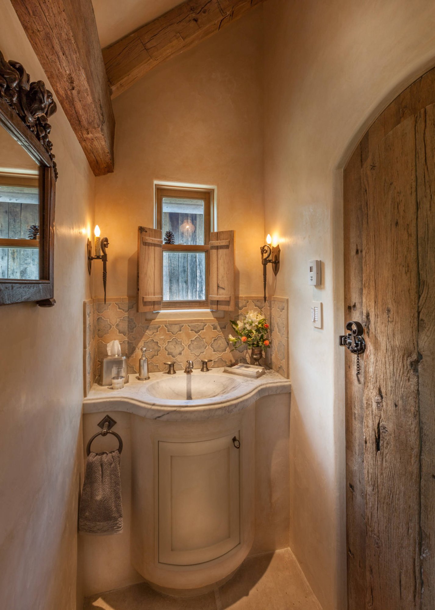 Small traditional beige tile slate floor bathroom with beige cabinets, marble countertops, beige walls, an integrated sink and raised-panel cabinets, by Jensen Design in Telluride, CO
