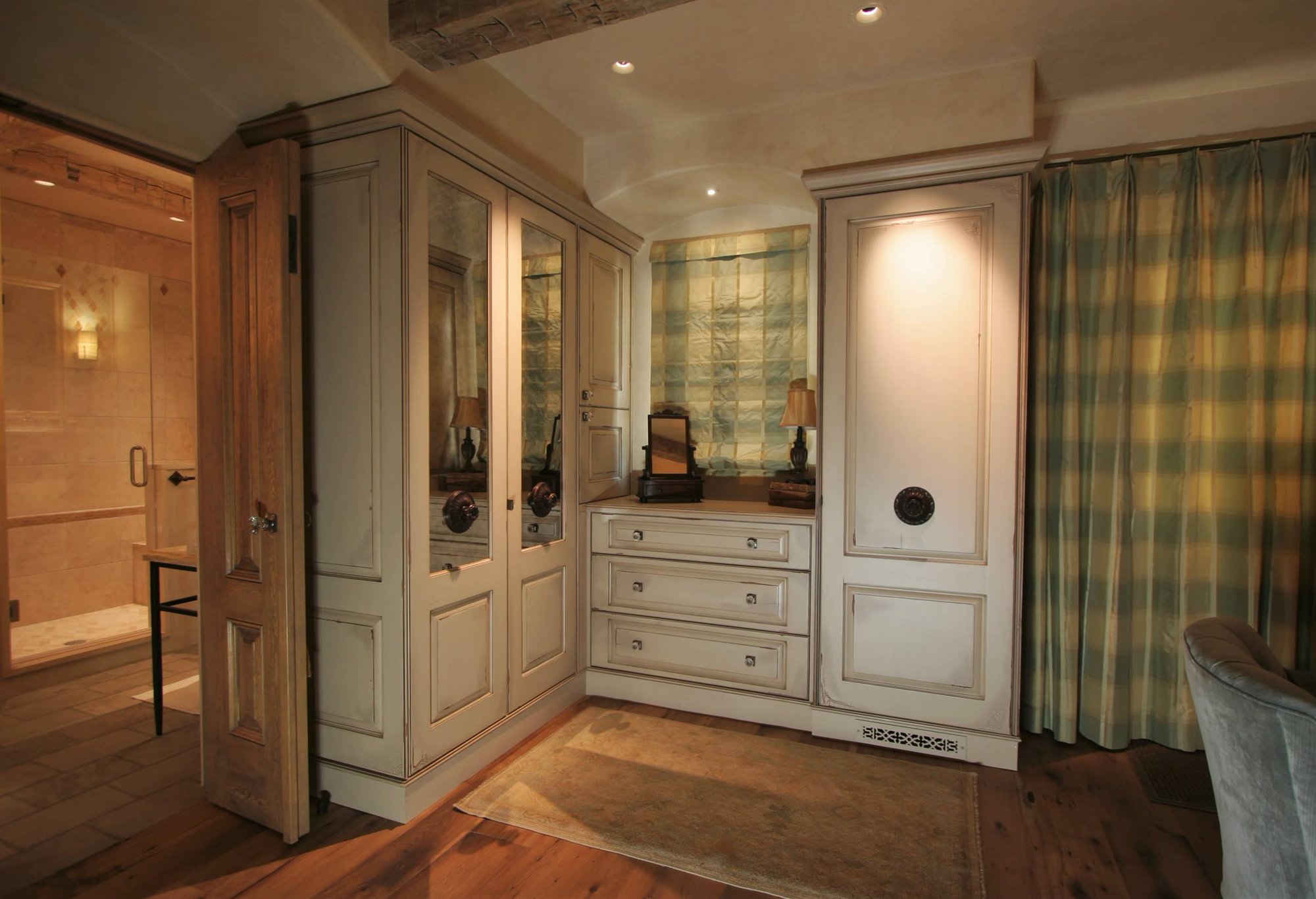Large timeless master dark wood floor bedroom with beige walls and no fireplace, by Jensen Design in Telluride, CO