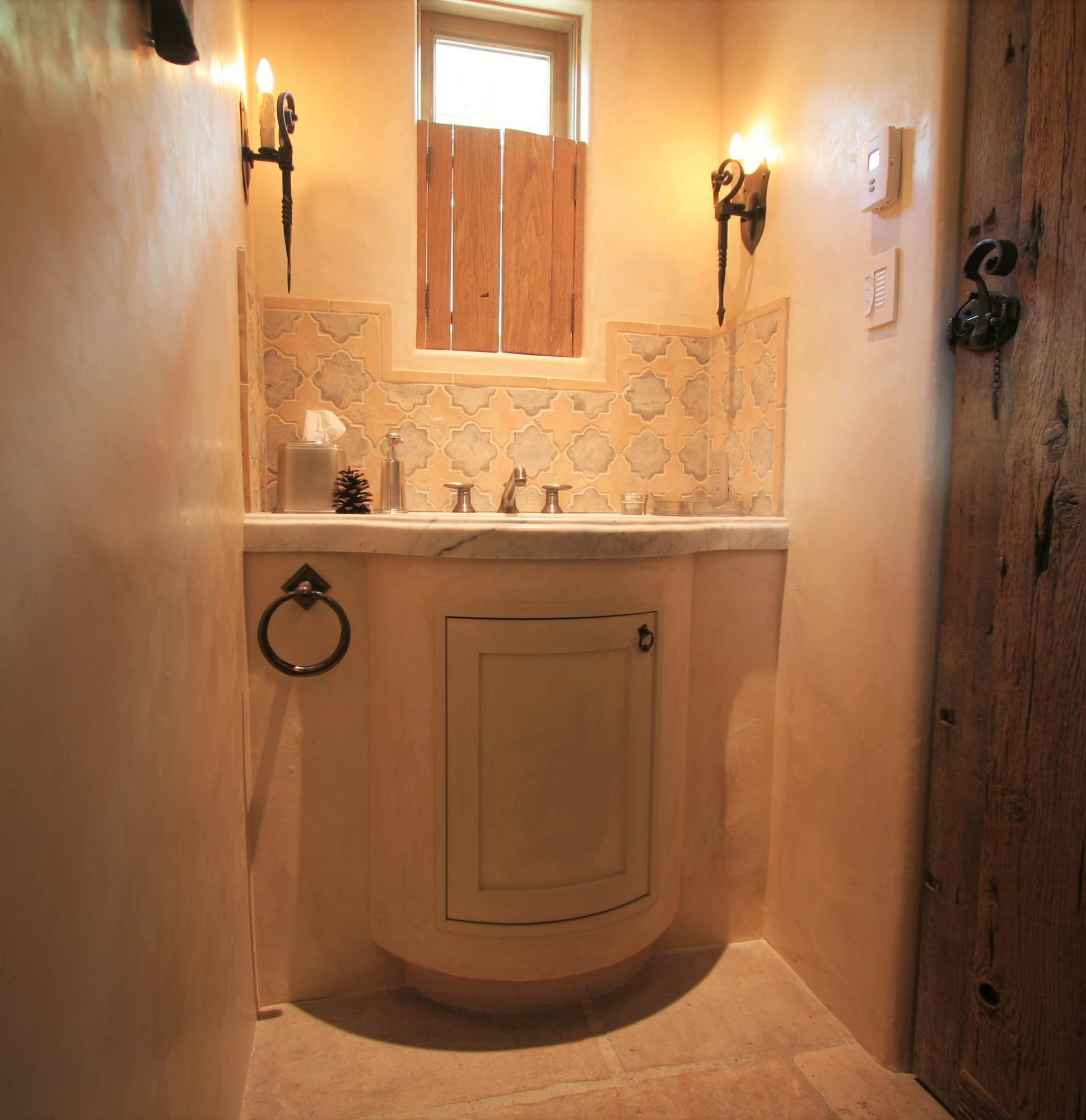 Small timeless beige tile slate floor bathroom with beige cabinets, beige walls, an integrated sink, marble countertops and raised-panel cabinets, by Jensen Design in Telluride, CO
