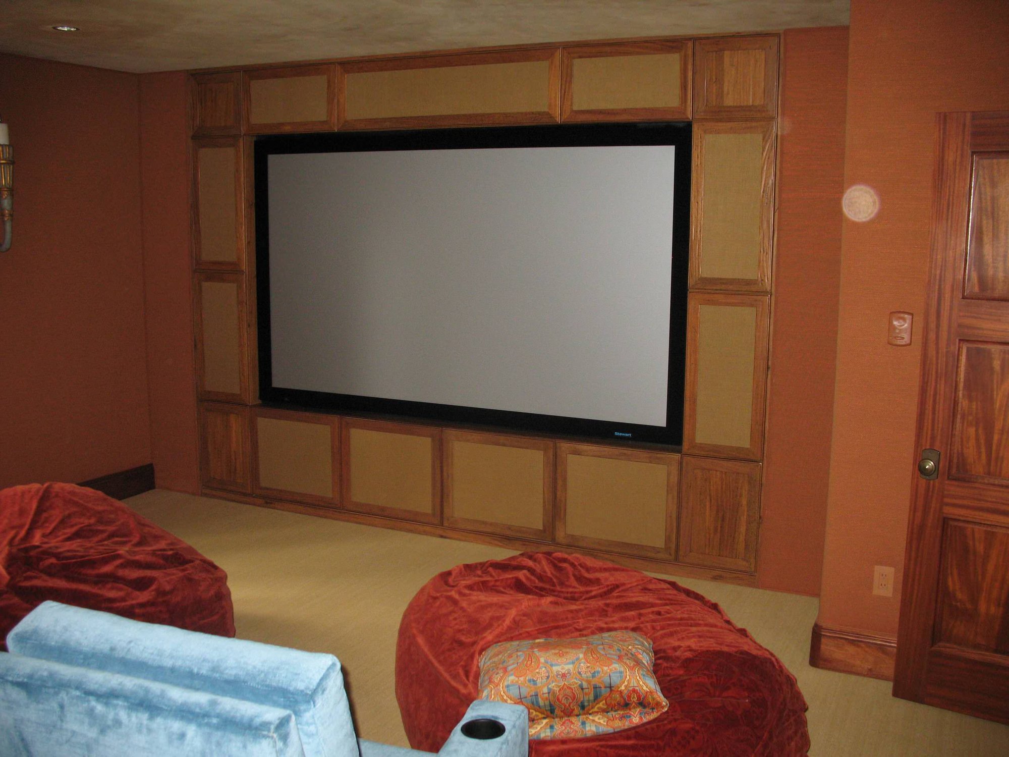Mid-sized elegant open concept carpeted home theater with a media wall, by Jensen Design in Telluride, CO