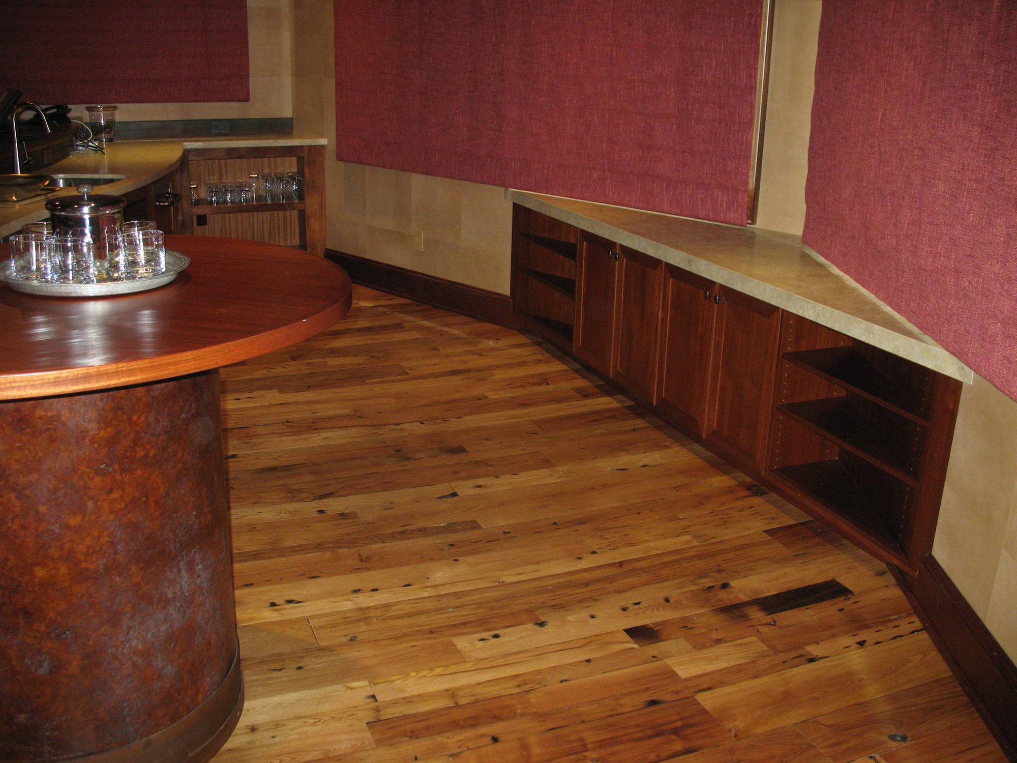 Mid-sized contemporary galley dark wood floor seated home bar with an undermount sink, open cabinets, dark wood cabinets and wood countertops, by Jensen Design in Telluride, CO
