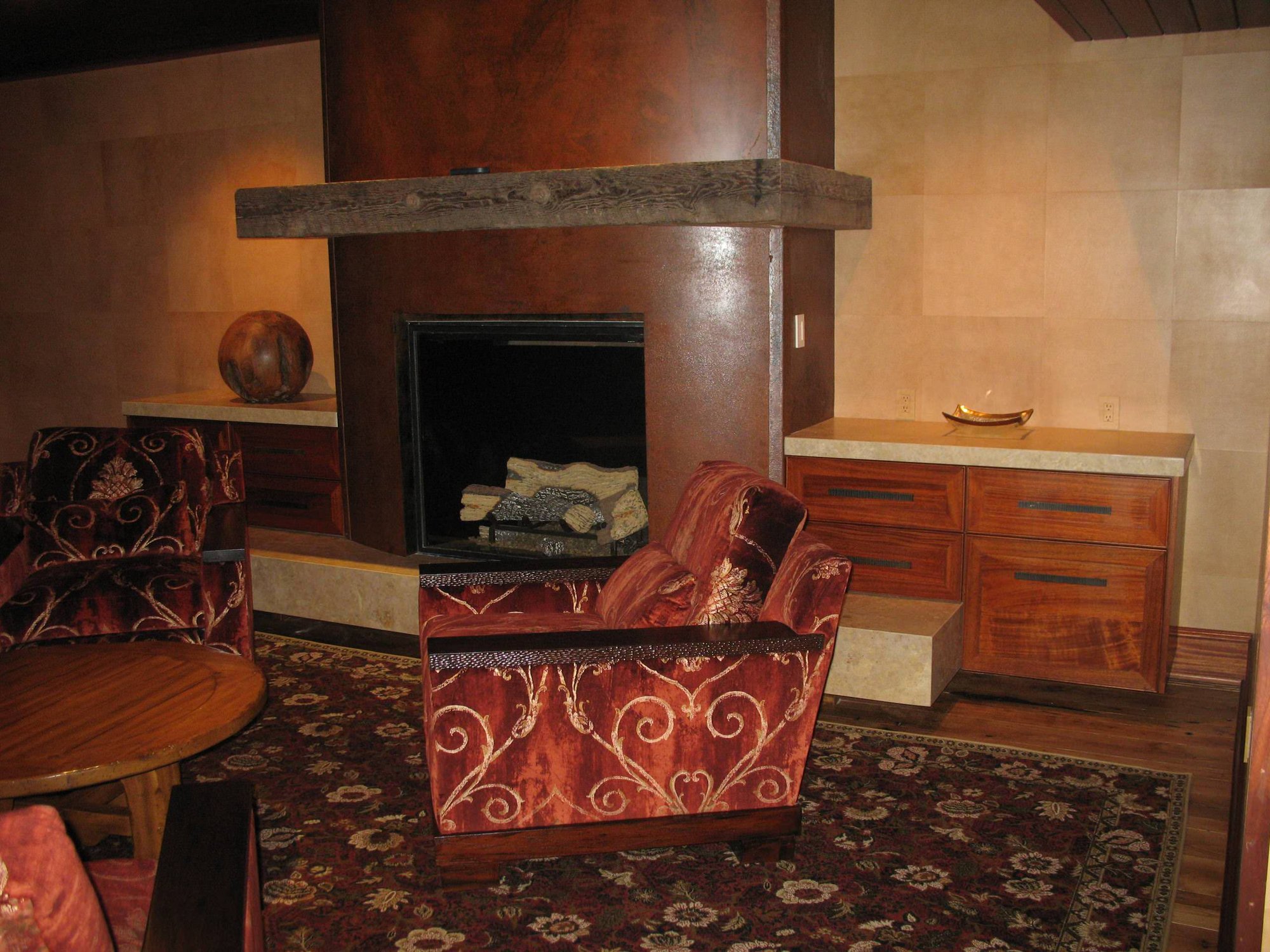 Mid-sized timeless open concept dark wood floor and brown floor game room with beige walls, a standard fireplace and a concrete fireplace, by Jensen Design in Telluride, CO