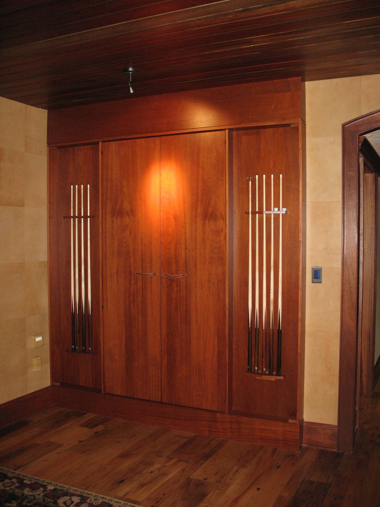 Mid-sized classic open concept dark wood floor and brown floor game room with beige walls, a standard fireplace and a concrete fireplace, by Jensen Design in Telluride, CO