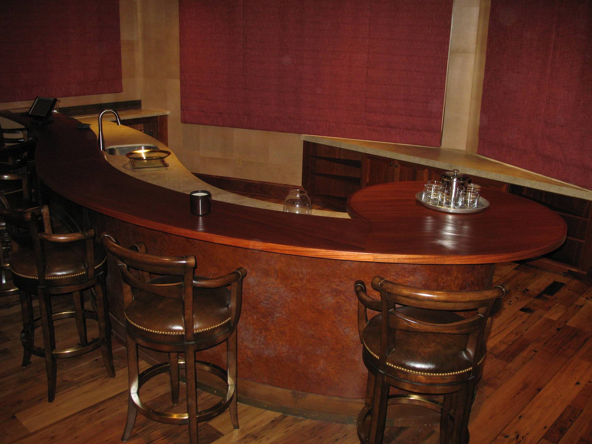 Mid-sized contemporary galley dark wood floor seated home bar with an undermount sink, dark wood cabinets and wood countertops, by Jensen Design in Telluride, CO