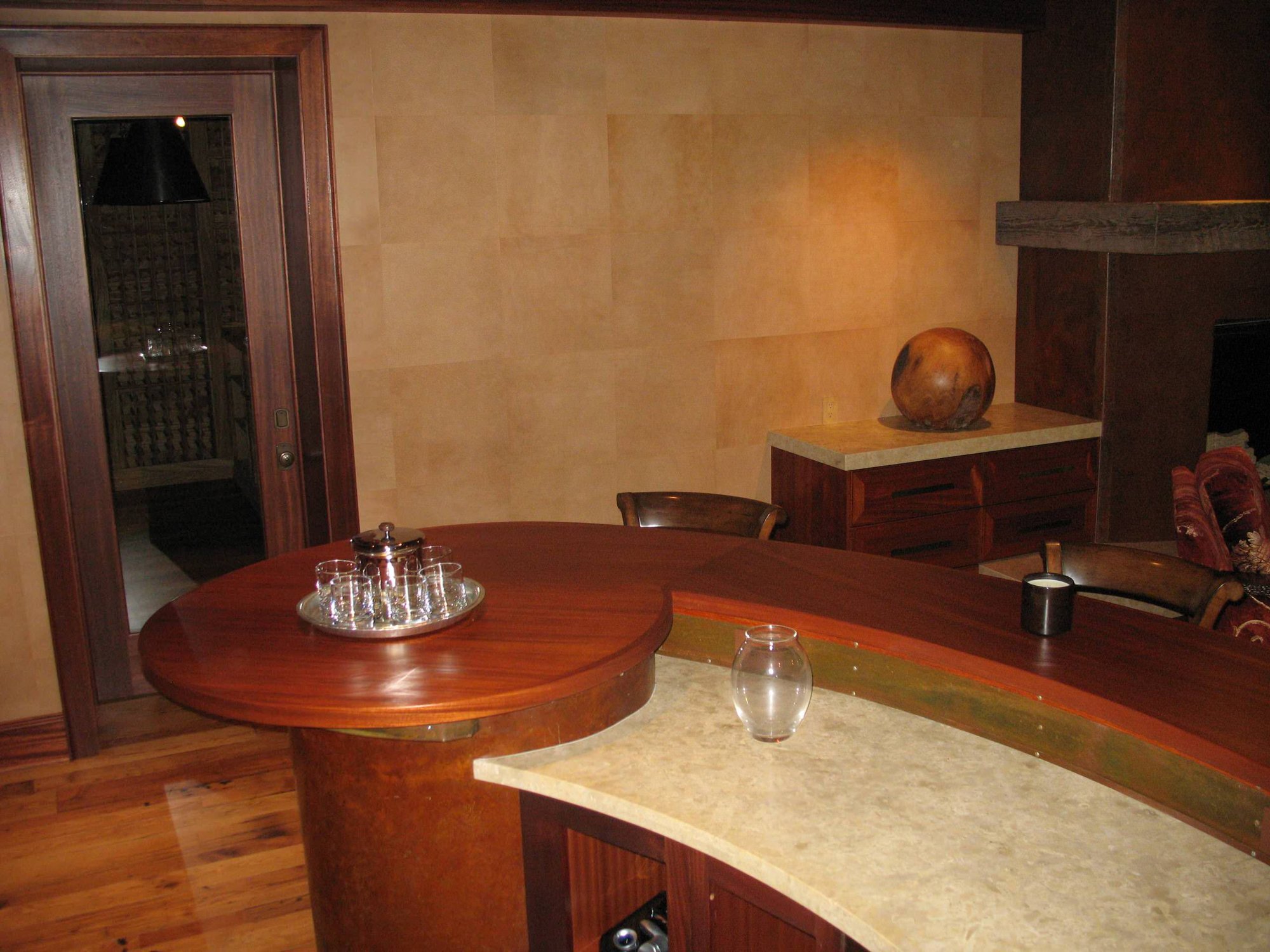 Mid-sized trendy galley dark wood floor seated home bar with an undermount sink, open cabinets, dark wood cabinets and wood countertops, by Jensen Design in Telluride, CO