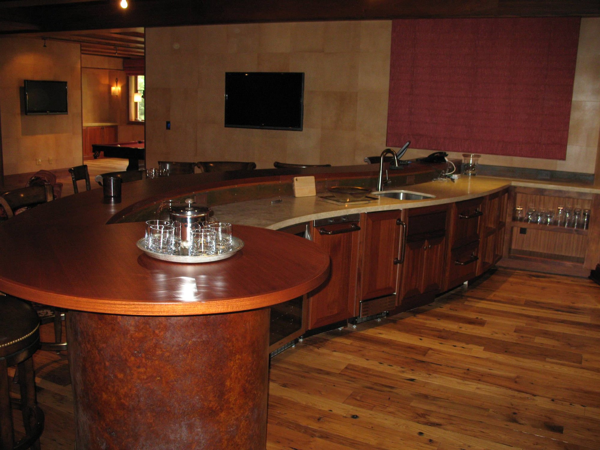 Mid-sized contemporary galley dark wood floor seated home bar with an undermount sink, open cabinets, dark wood cabinets and wood countertops, by Jensen Design in Telluride, CO