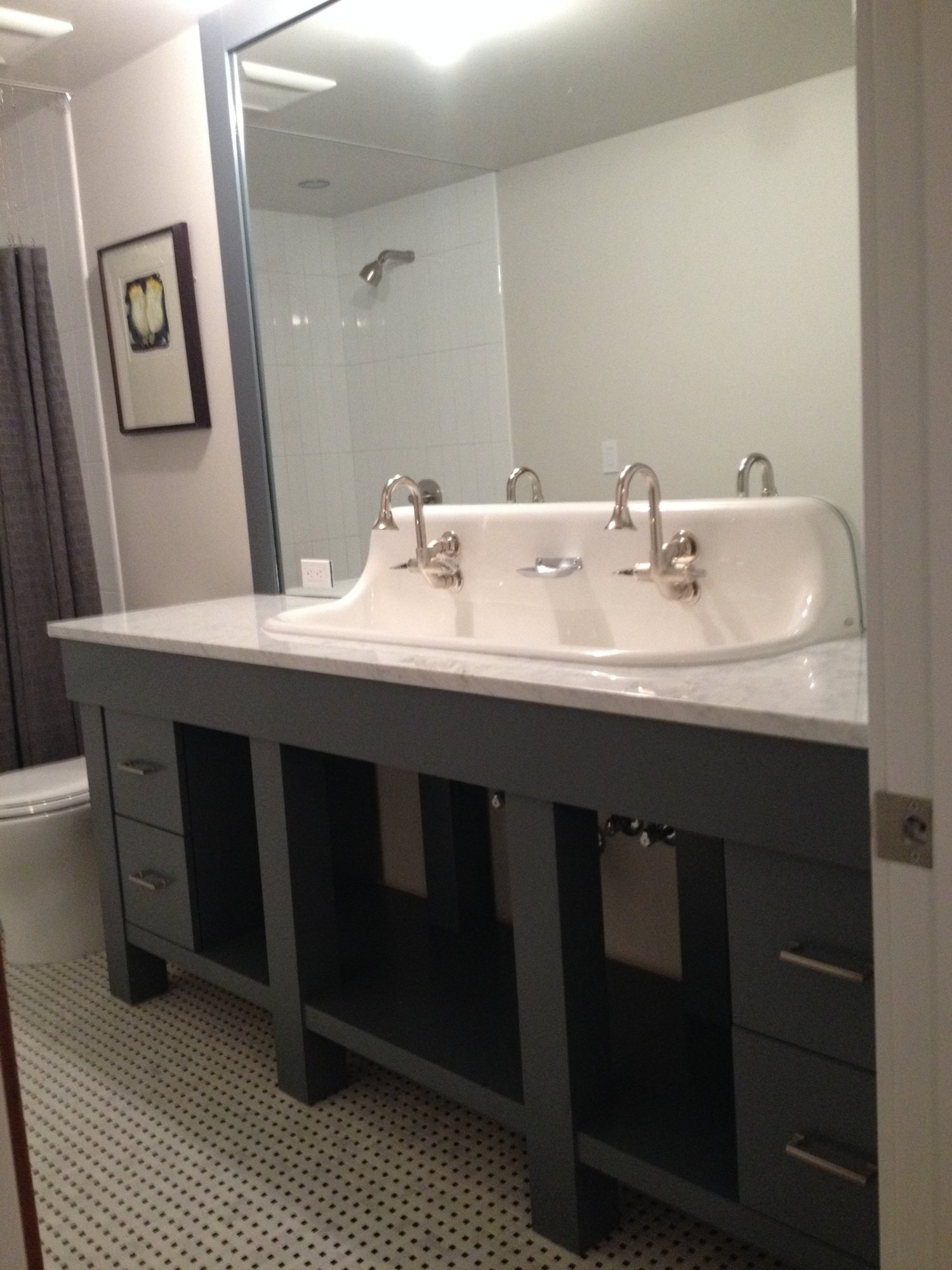 Mid-sized trendy kids' black and white tile and porcelain tile mosaic tile floor bathroom with gray cabinets, white walls, a trough sink, quartzite countertops, flat-panel cabinets and a one-piece toilet, by Jensen Design in Telluride, CO