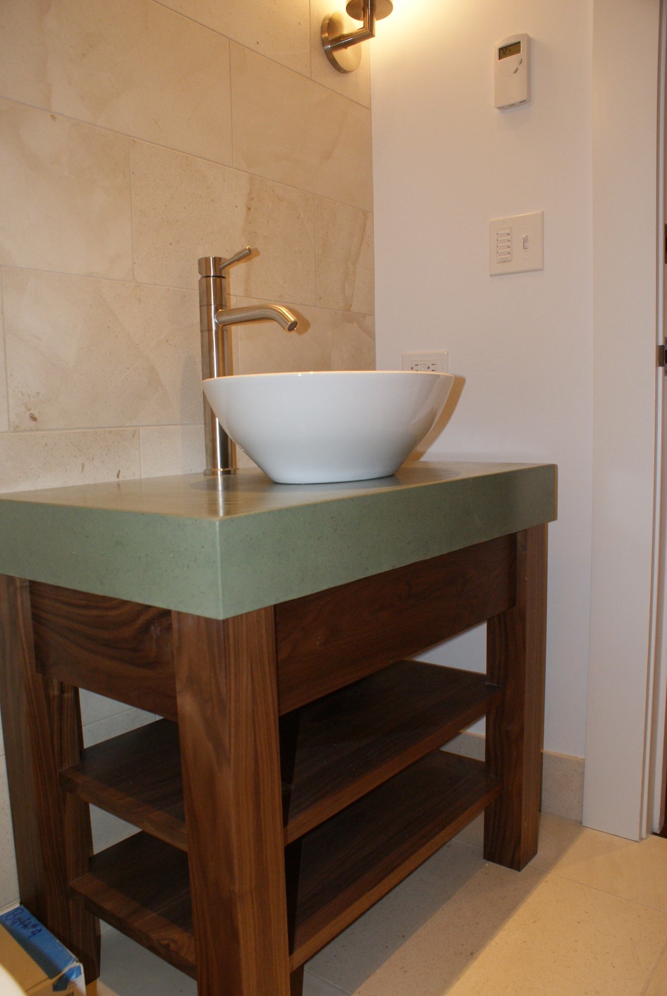 Mid-sized contemporary 3/4 beige tile and porcelain tile porcelain tile bathroom with a vessel sink, open cabinets, dark wood cabinets, a one-piece toilet and beige walls, by Jensen Design in Telluride, CO