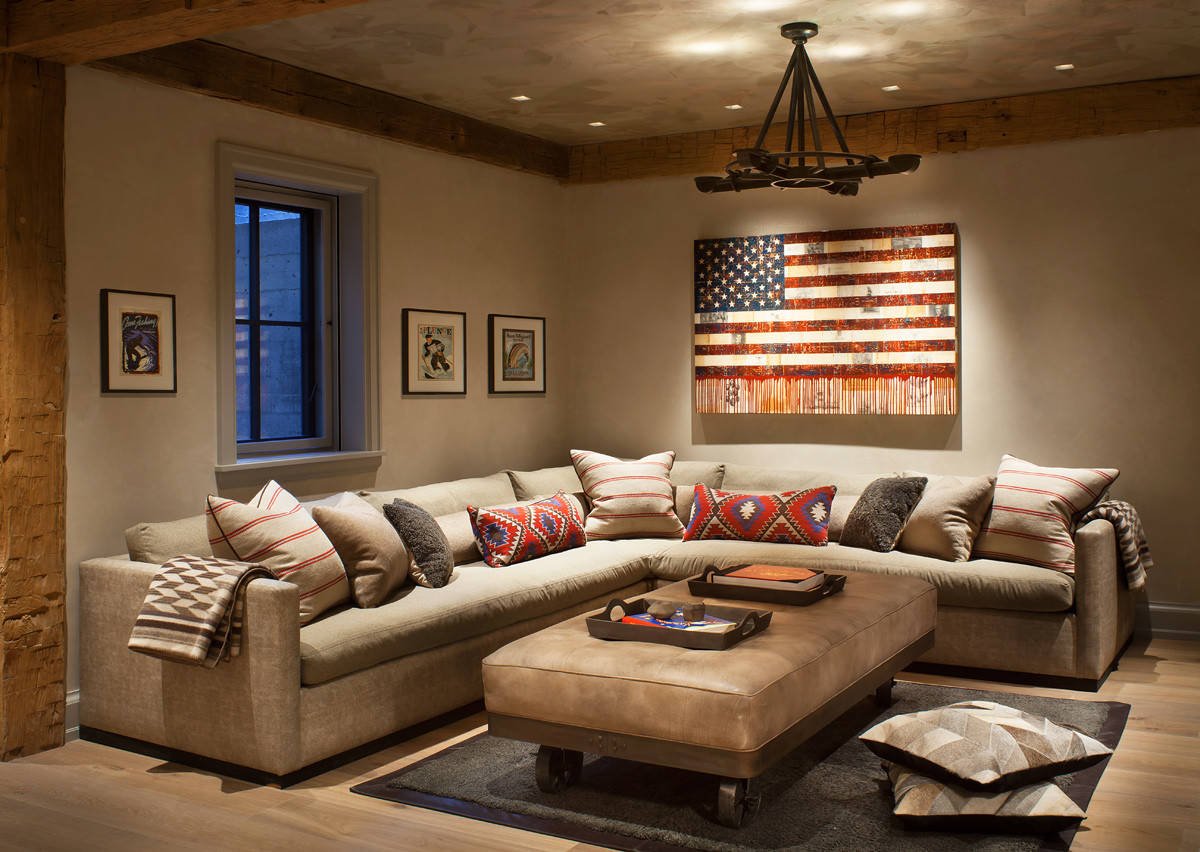 Rustic medium tone wood floor family room with beige walls, by Jensen Design in Telluride, CO