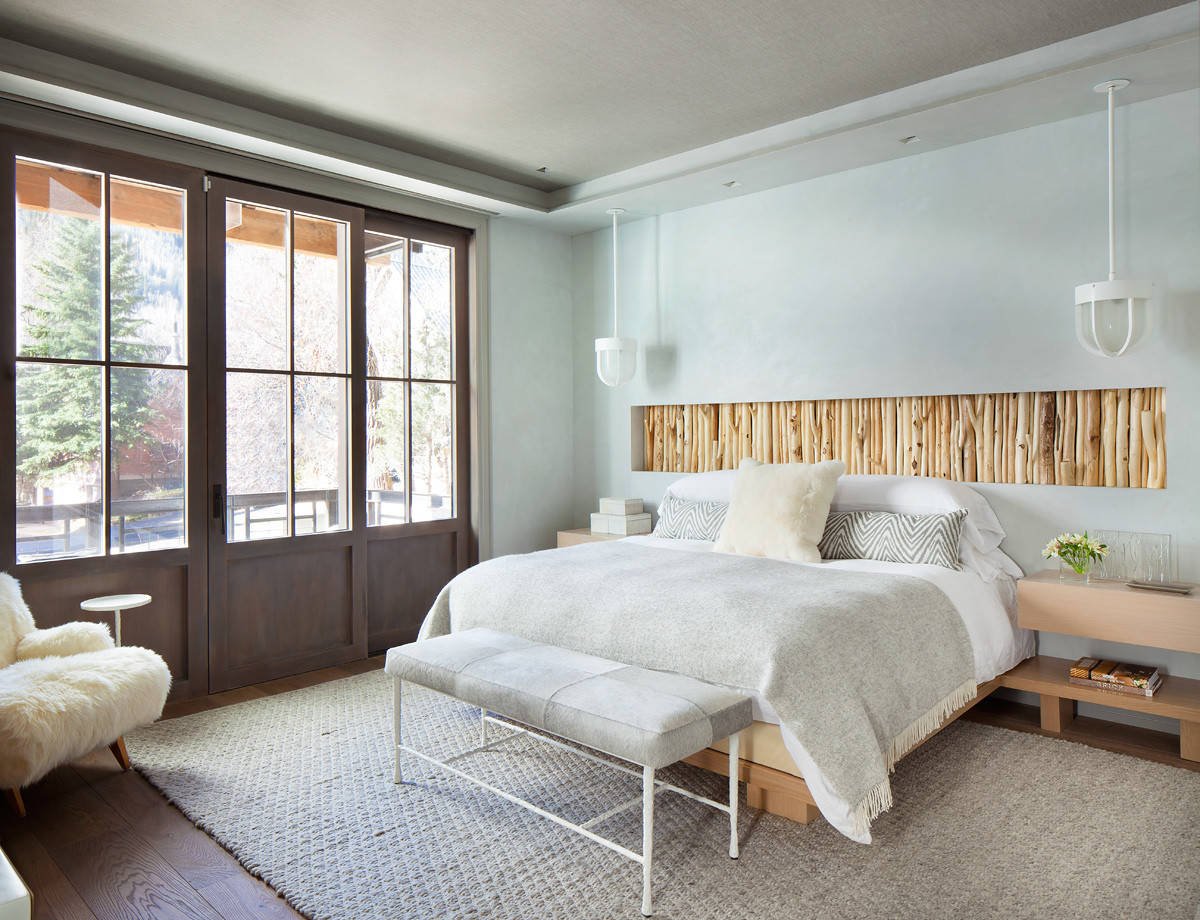 Rustic dark wood floor bedroom with gray walls, by Jensen Design in Telluride, CO