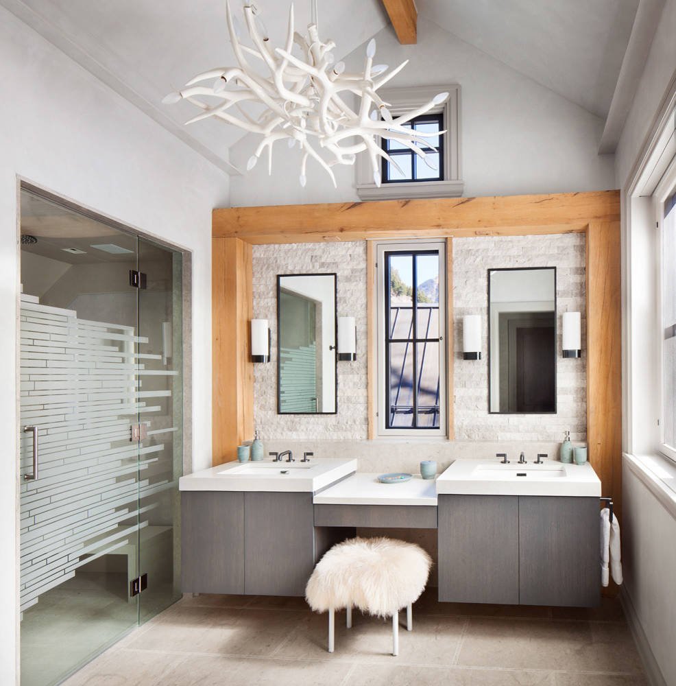 Mountain style beige tile and stone tile alcove shower with flat-panel cabinets, gray cabinets, white walls, an undermount sink and a hinged shower door, by Jensen Design in Telluride, CO