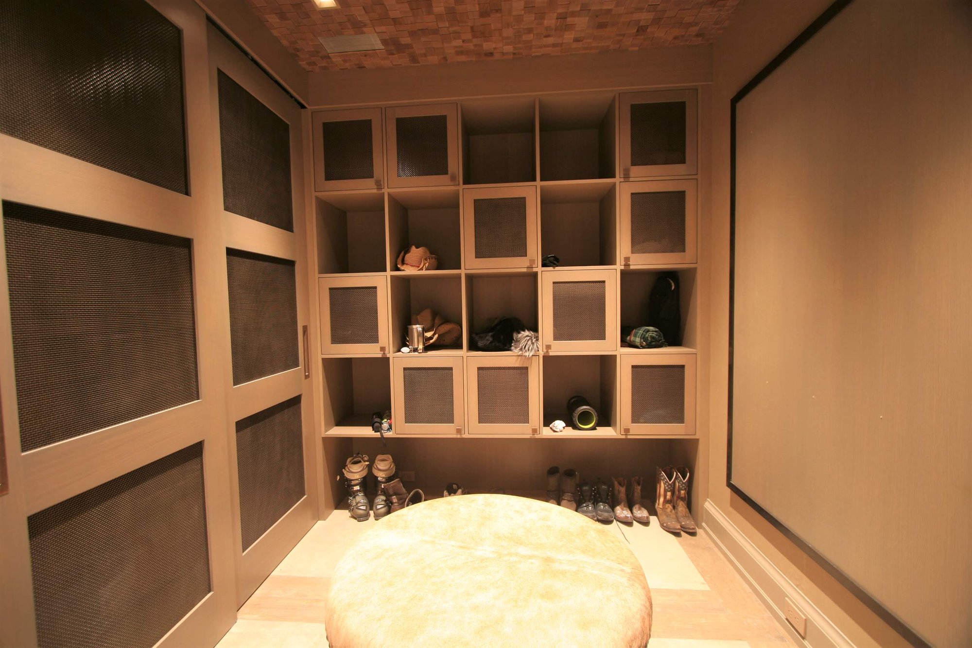 Mid-sized modern light wood floor mudroom with beige walls, by Jensen Design in Telluride, CO