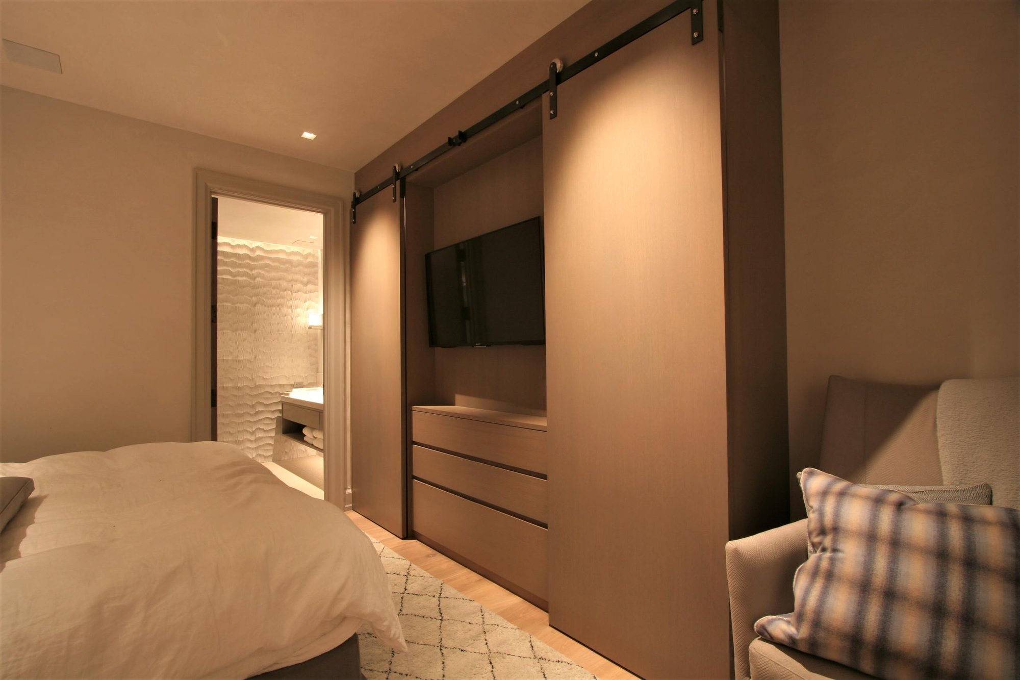Mid-sized modern master light wood floor bedroom with no fireplace and beige walls, by Jensen Design in Telluride, CO