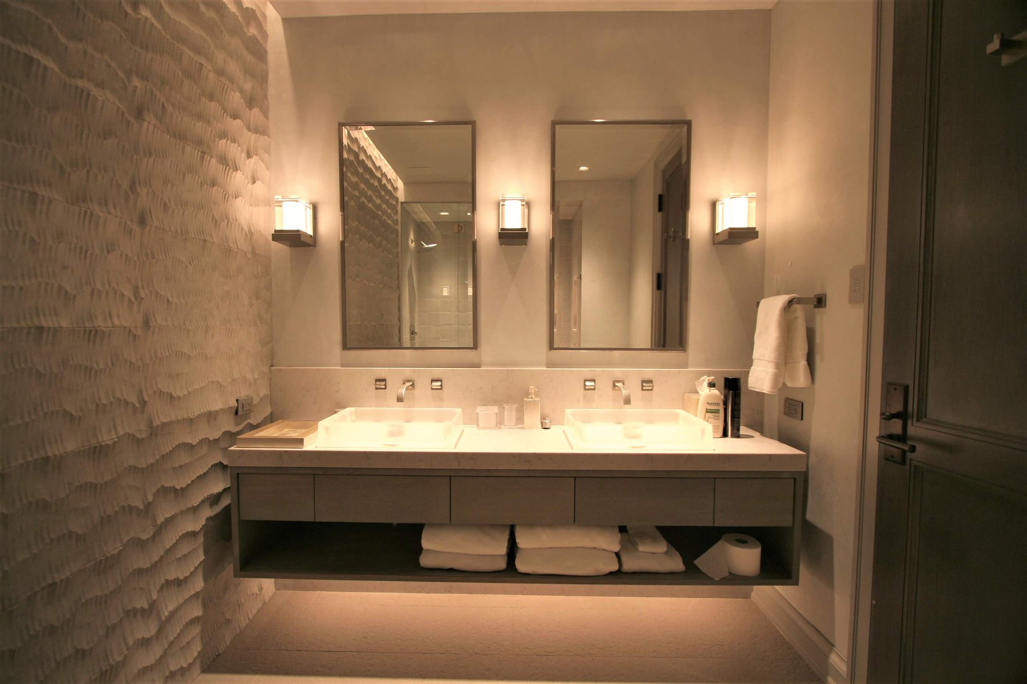 Mid-sized minimalist 3/4 bathroom with flat-panel cabinets, a vessel sink, gray cabinets, gray walls and solid surface countertops, by Jensen Design in Telluride, CO