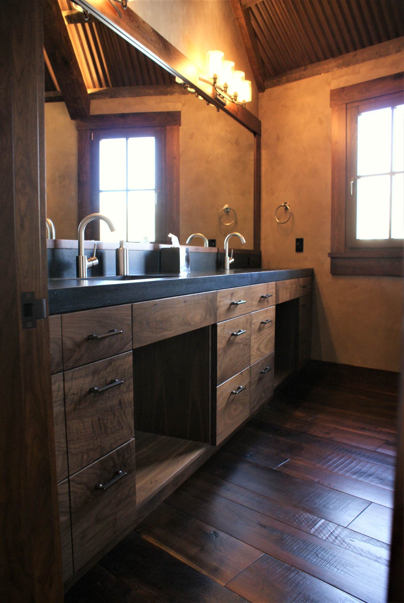 Mid-sized arts and crafts master dark wood floor bathroom with flat-panel cabinets, an undermount sink, dark wood cabinets, beige walls and concrete countertops, by Jensen Design in Telluride, CO