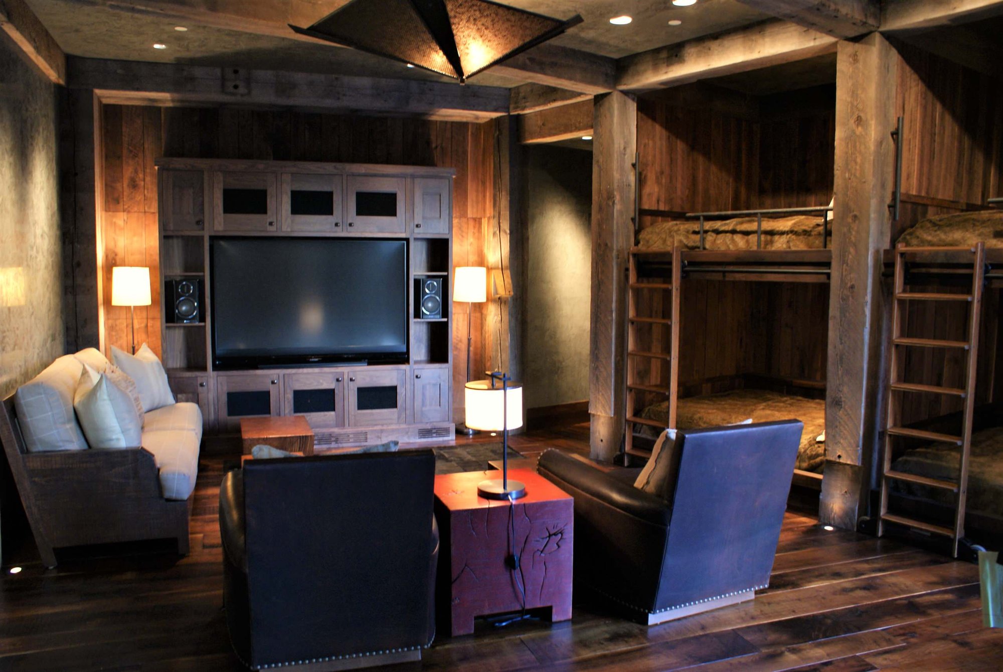 Mid-sized arts and crafts open concept dark wood floor family room with gray walls, no fireplace and a media wall, by Jensen Design in Telluride, CO