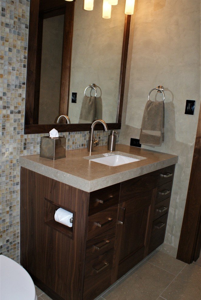 Mid-sized classic 3/4 porcelain tile bathroom with an undermount sink, flat-panel cabinets, dark wood cabinets and beige walls, by Jensen Design in Telluride, CO