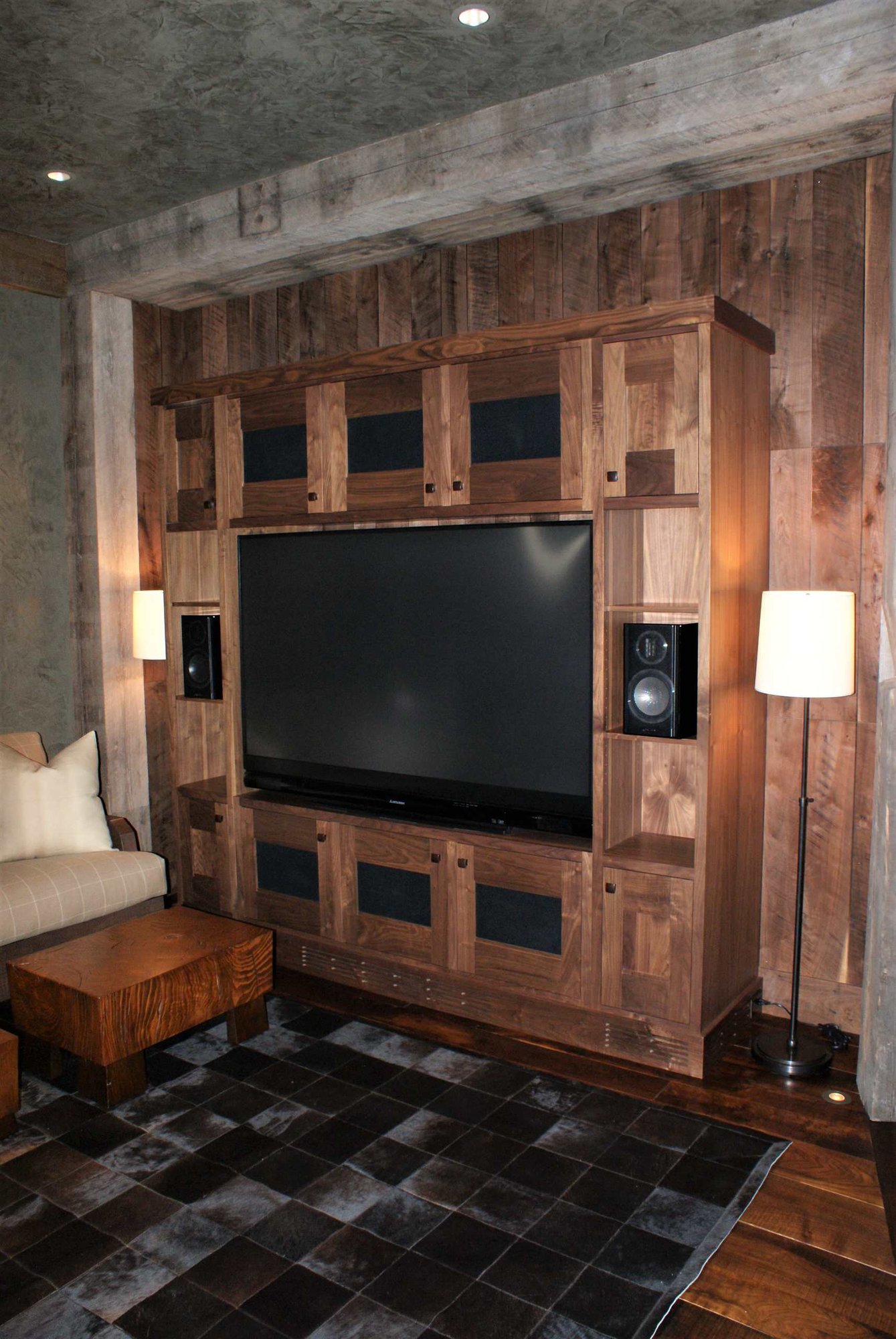 Mid-sized craftsman open concept dark wood floor family room with a media wall, gray walls and no fireplace, by Jensen Design in Telluride, CO