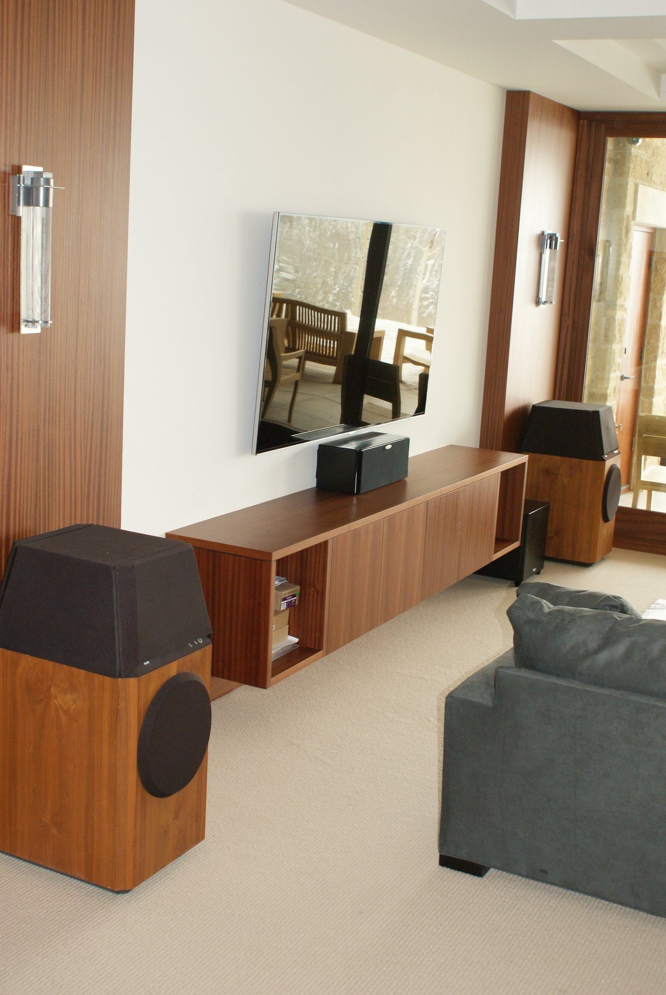 Mid-sized contemporary open concept carpeted game room with a wall-mounted tv, white walls and no fireplace, by Jensen Design in Telluride, CO