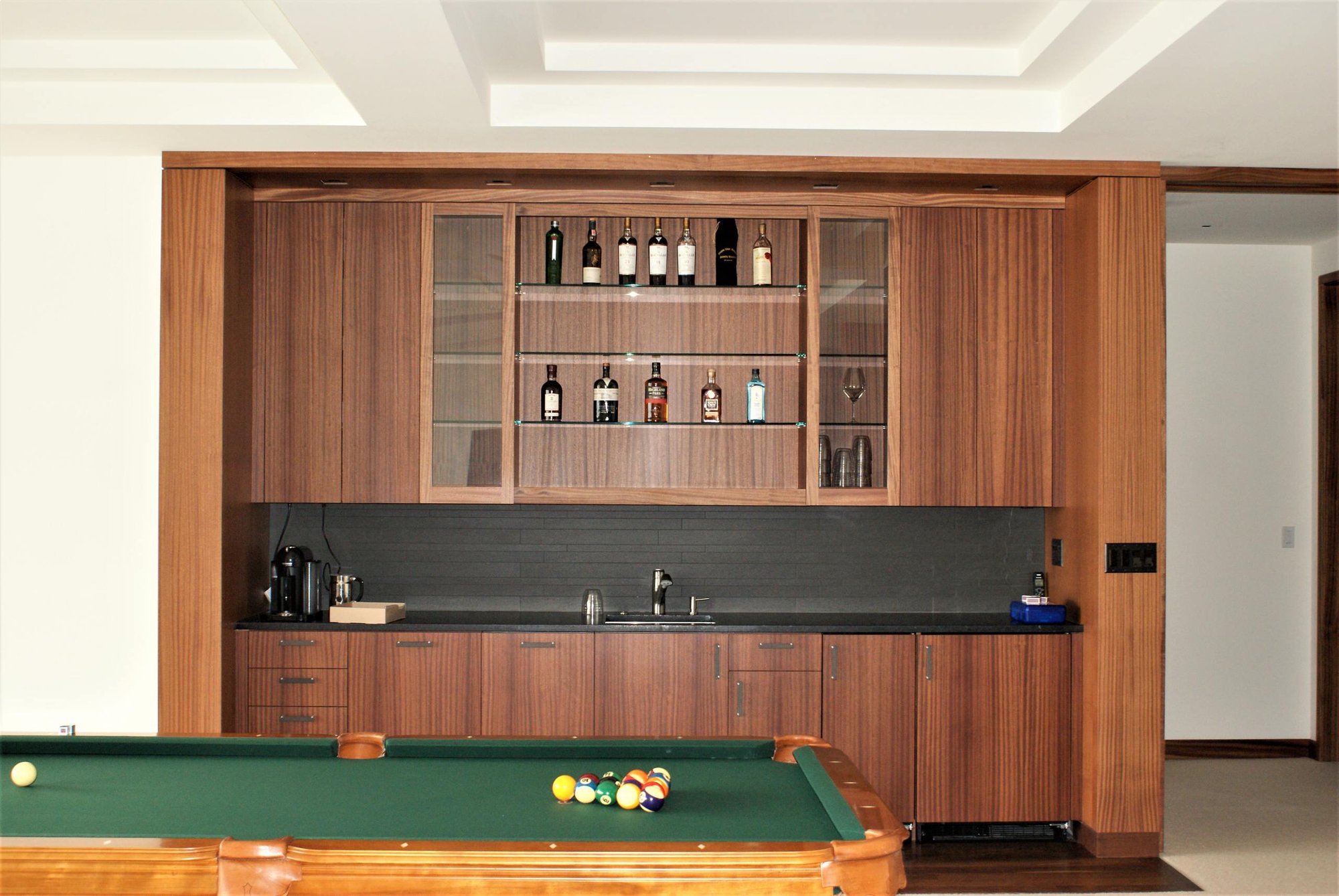 Mid-sized contemporary open concept carpeted game room with white walls, no fireplace and a wall-mounted tv, by Jensen Design in Telluride, CO
