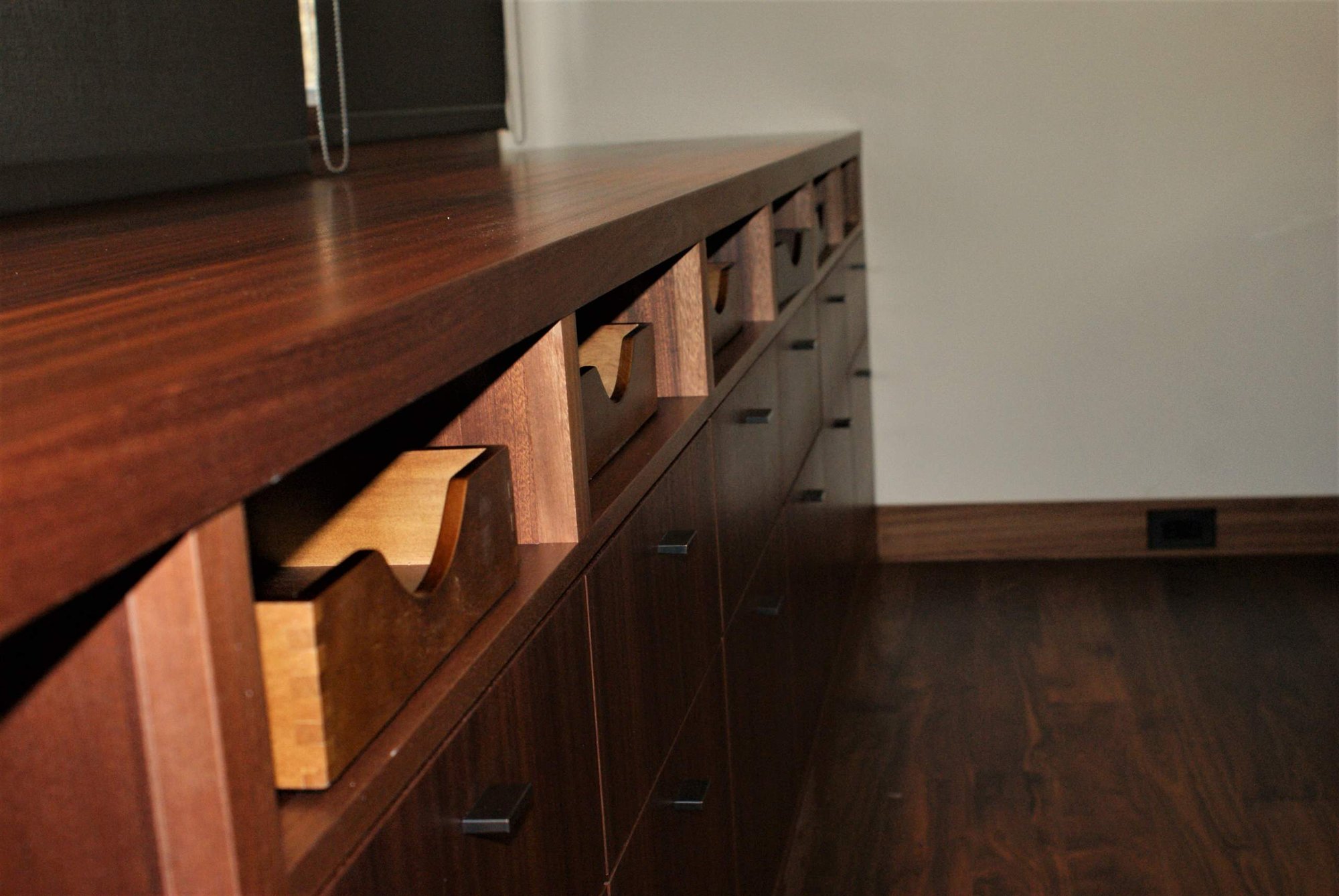 Large trendy built-in desk dark wood floor study room with white walls, by Jensen Design in Telluride, CO