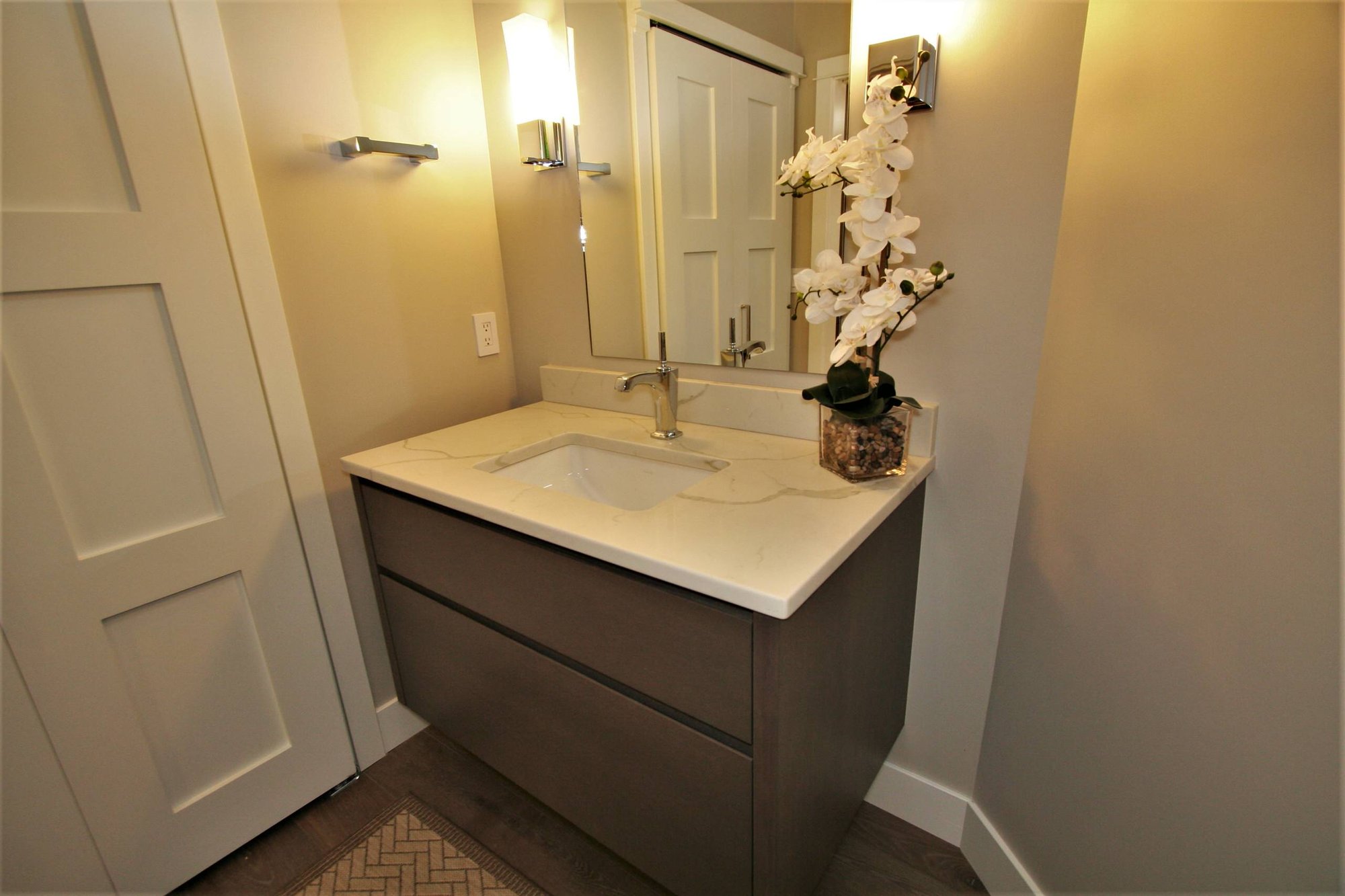 Small contemporary 3/4 medium tone wood floor and brown floor bathroom with flat-panel cabinets, medium tone wood cabinets, an undermount sink, marble countertops and beige walls, by Jensen Design in Telluride, CO
