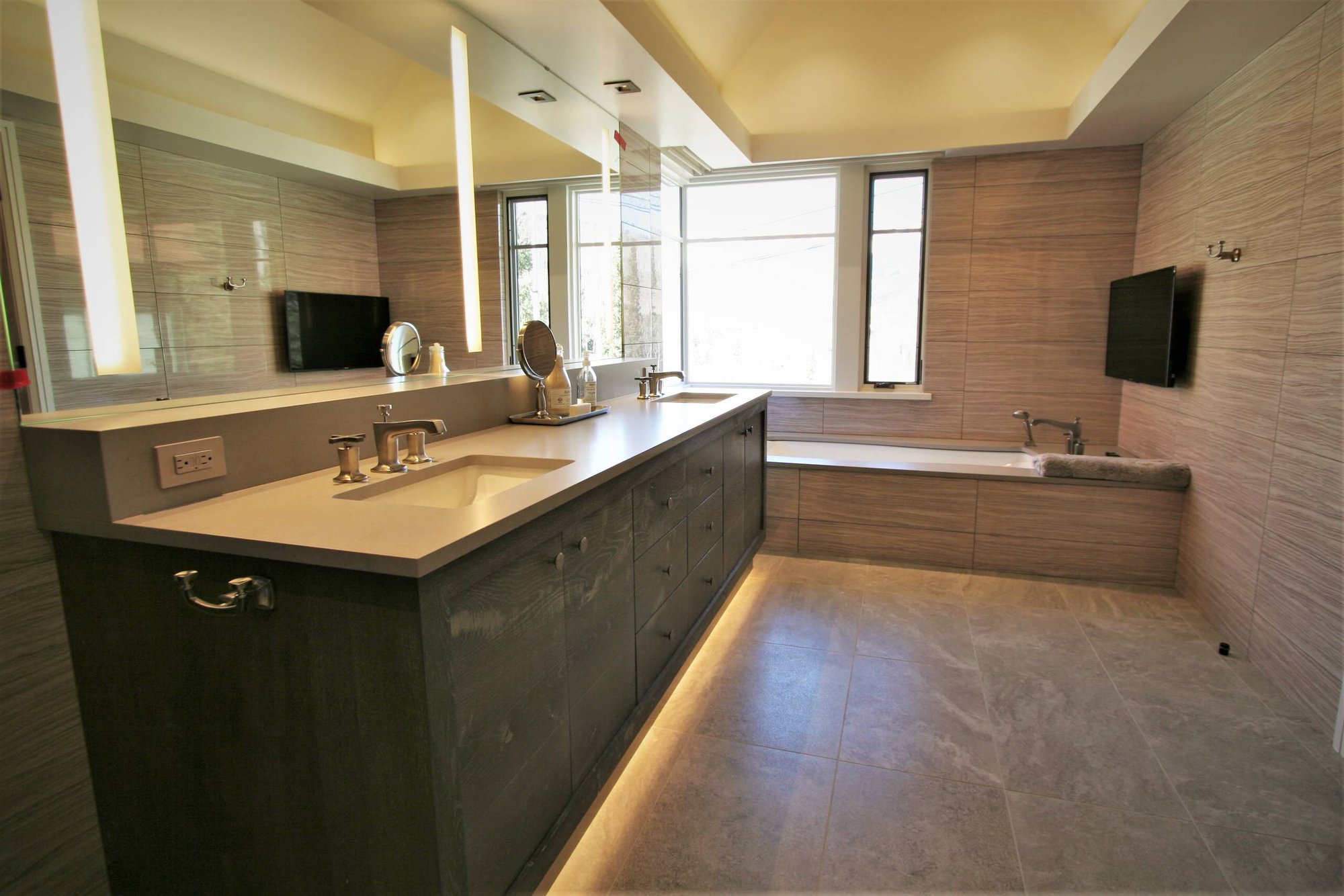 Large trendy master beige tile and porcelain tile ceramic tile and beige floor walk-in shower with flat-panel cabinets, gray cabinets, an undermount tub, an undermount sink, concrete countertops, a hinged shower door and beige walls, by Jensen Design in Mountain Village, CO