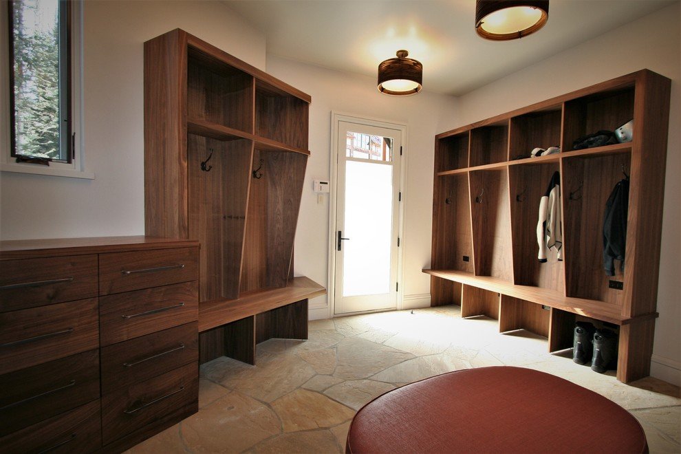 Large mountain style beige floor entryway with a white front door and beige walls, by Jensen Design in Mountain Village, CO
