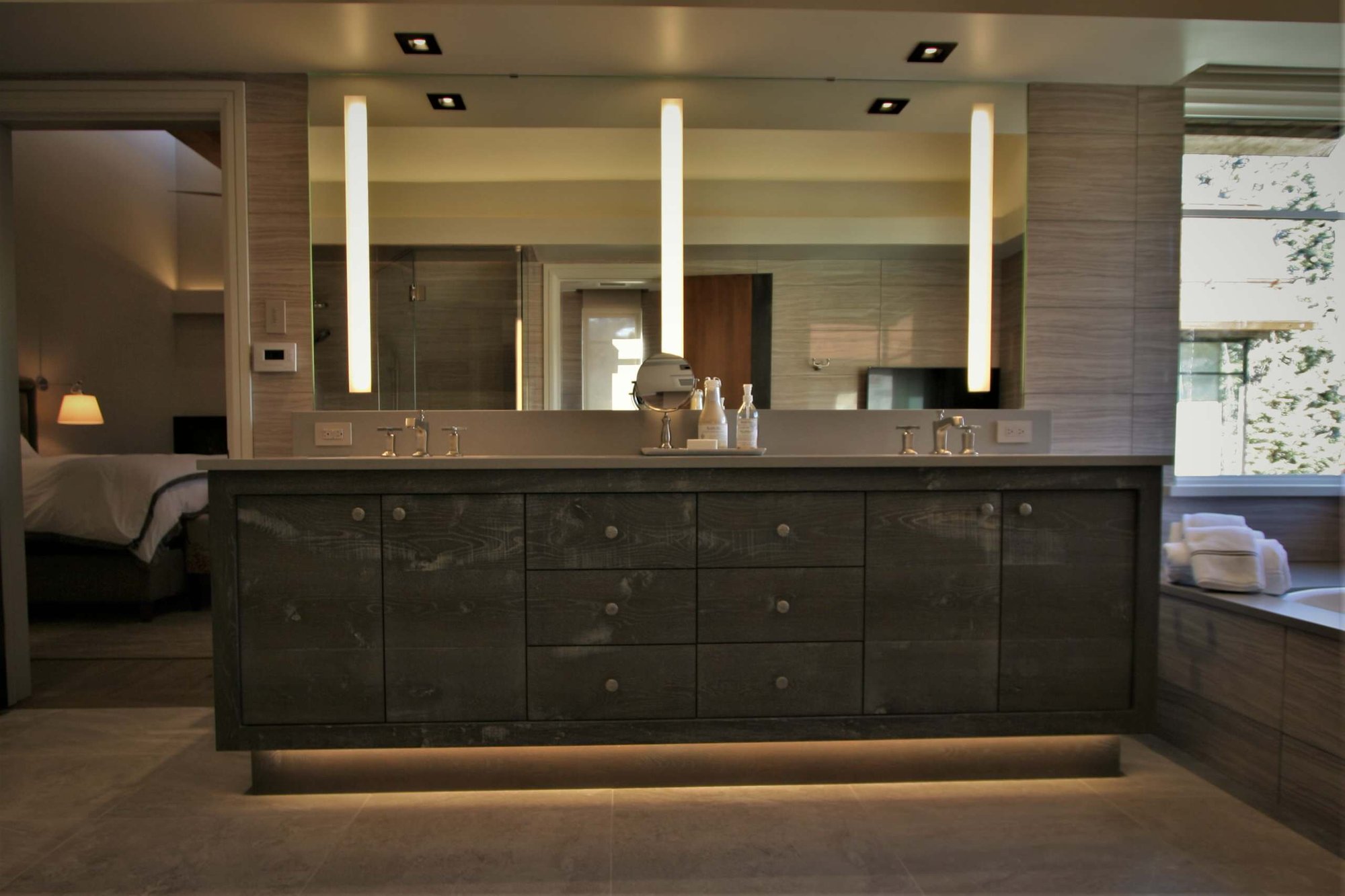 Large trendy master beige tile and porcelain tile ceramic tile and beige floor walk-in shower with flat-panel cabinets, gray cabinets, an undermount tub, an undermount sink, concrete countertops, a hinged shower door and beige walls, by Jensen Design in Mountain Village, CO