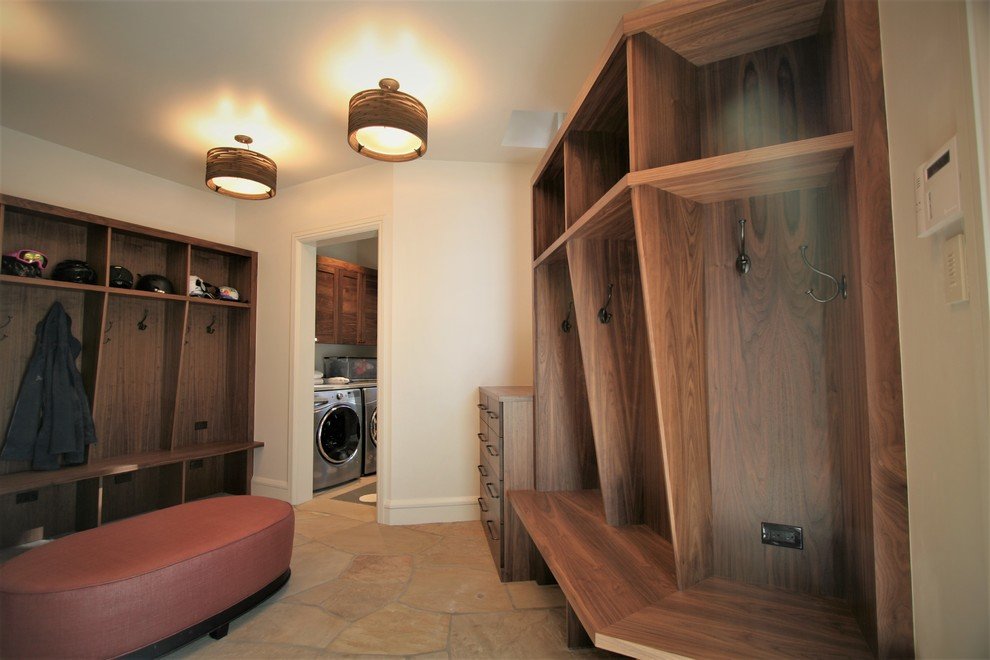 Large mountain style beige floor mudroom with beige walls, by Jensen Design in Mountain Village, CO