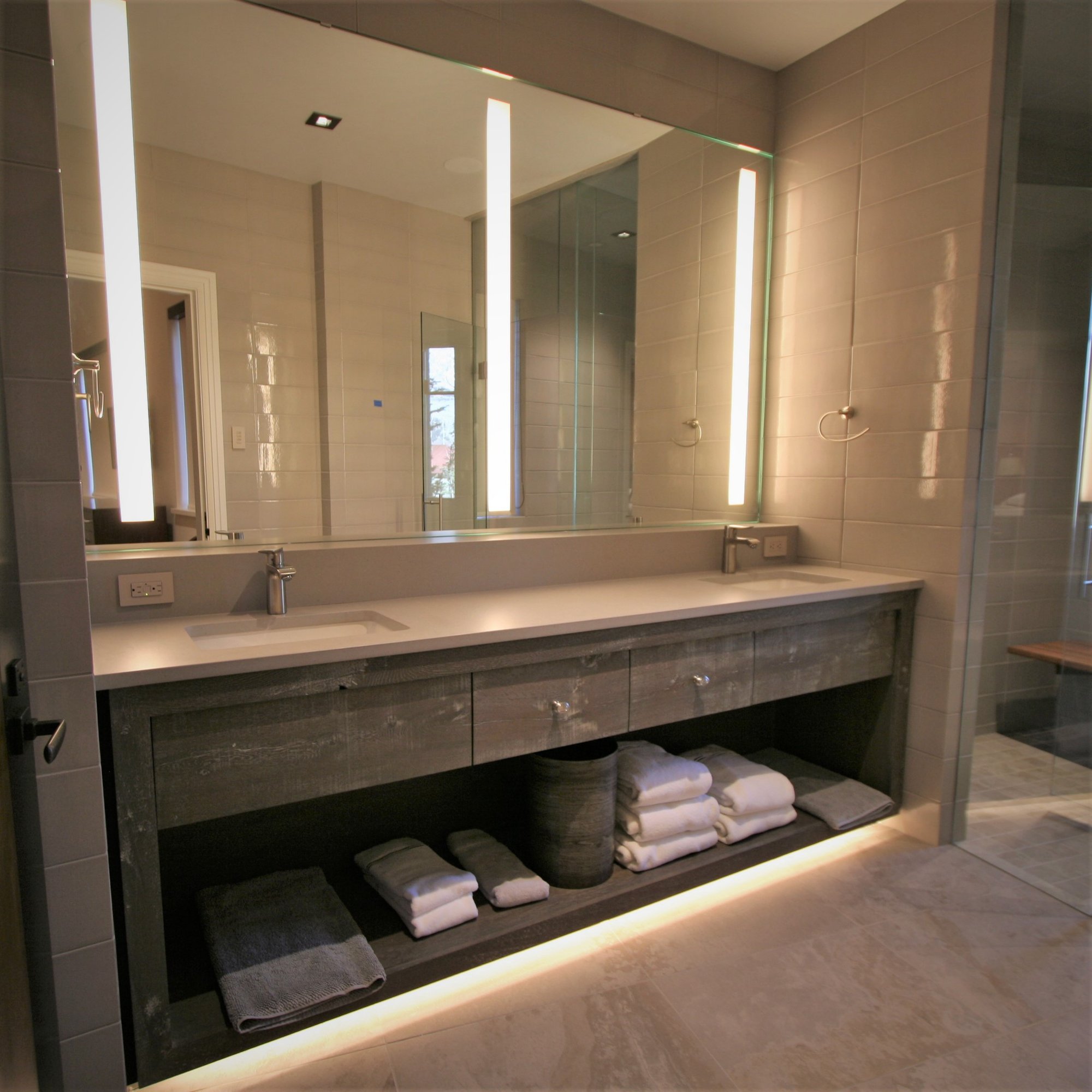 Mid-sized trendy master gray tile ceramic tile and gray floor walk-in shower with open cabinets, gray cabinets, an undermount sink, concrete countertops and a hinged shower door, by Jensen Design in Mountain Village, CO