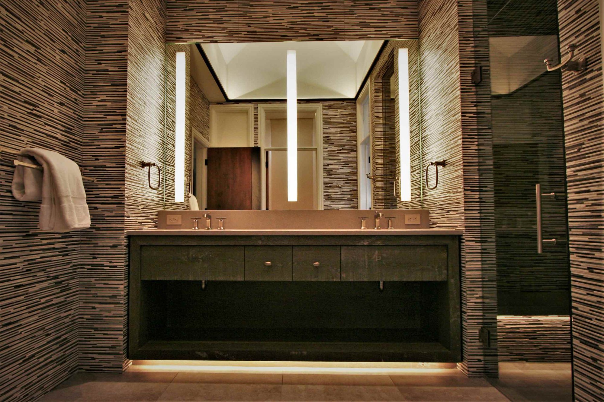 Mid-sized contemporary master black and white tile and matchstick tile brown floor bathroom with open cabinets, gray cabinets, an undermount sink, concrete countertops, a hinged shower door and brown walls, by Jensen Design in Mountain Village, CO