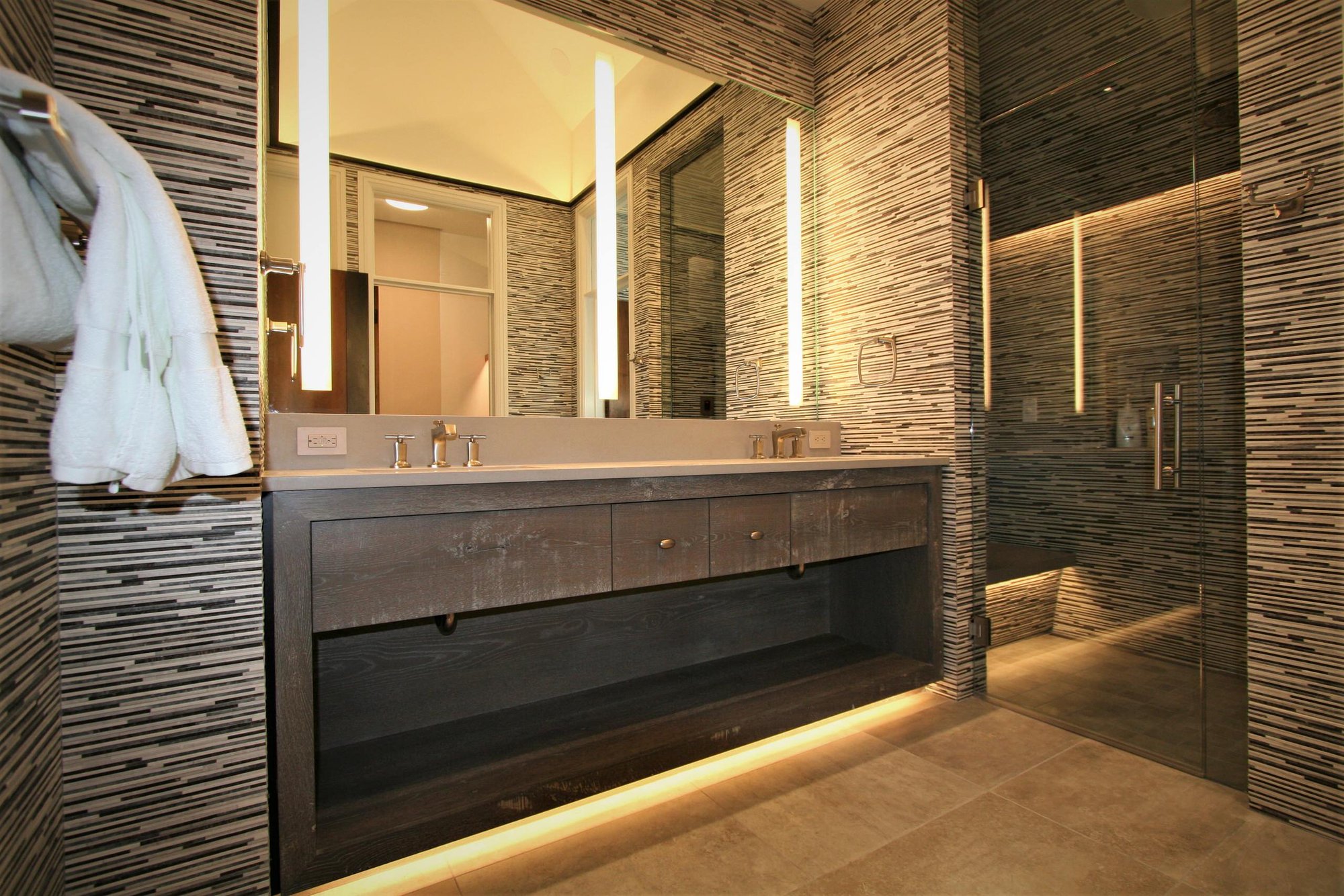 Mid-sized contemporary master black and white tile and matchstick tile brown floor bathroom with open cabinets, gray cabinets, an undermount sink, concrete countertops, a hinged shower door and brown walls, by Jensen Design in Mountain Village, CO