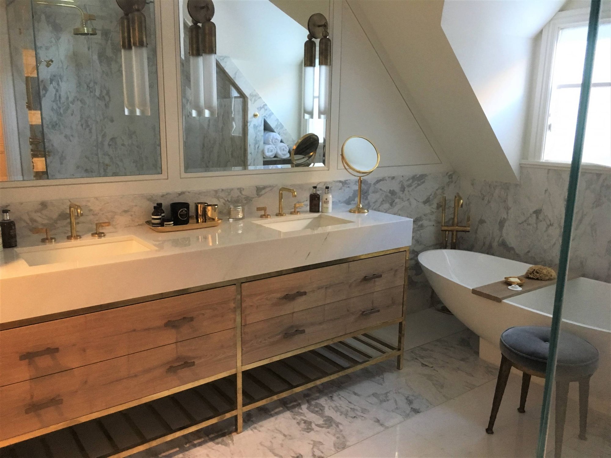 Large minimalist master white tile and marble tile marble floor and white floor bathroom with flat-panel cabinets, light wood cabinets, a one-piece toilet, white walls, an undermount sink, marble countertops and a hinged shower door, by Jensen Design in Telluride, CO