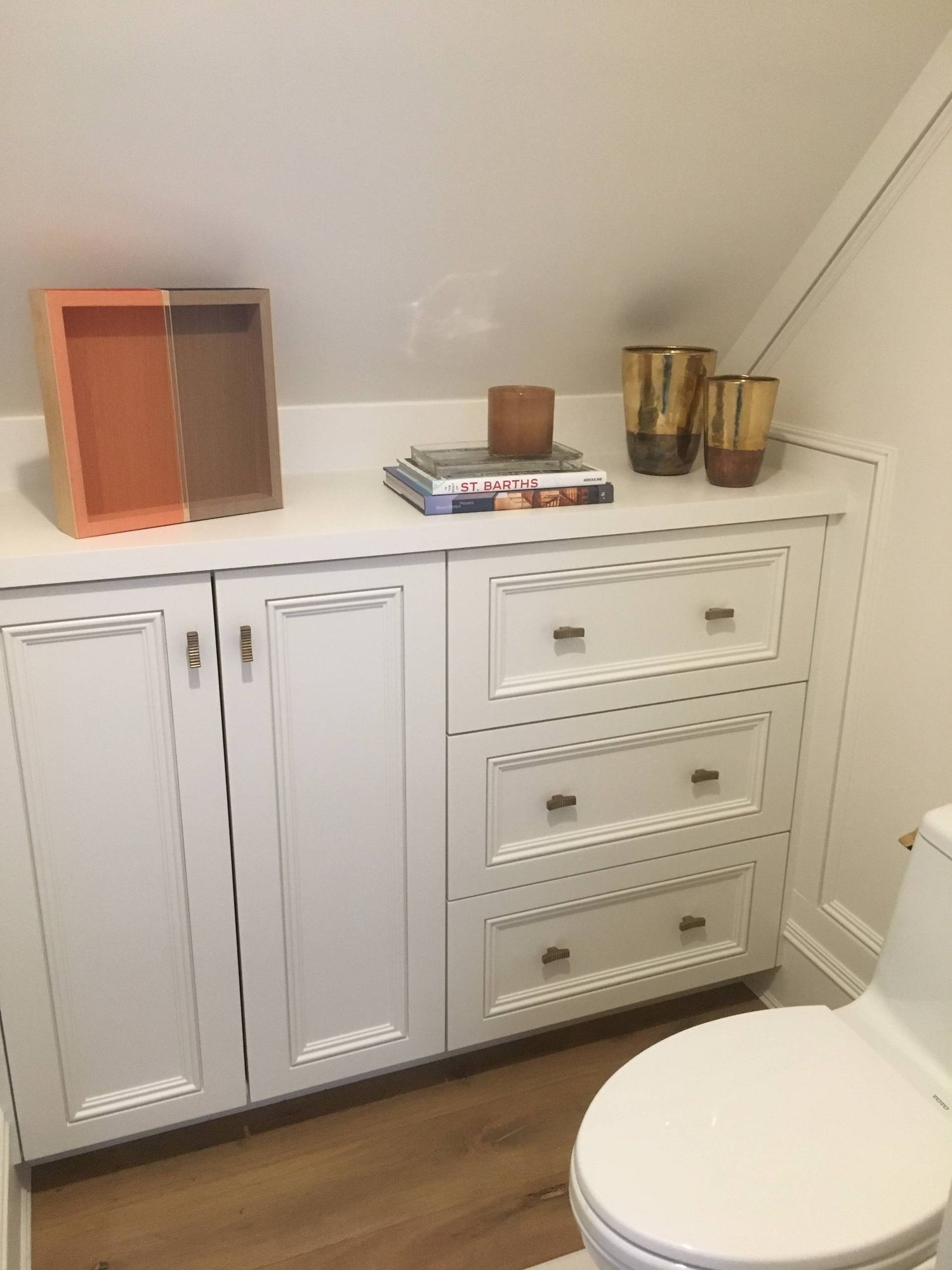 Large modern master light wood floor bathroom with recessed-panel cabinets, white cabinets, a one-piece toilet, white walls, wood countertops and a hinged shower door, by Jensen Design in Telluride, CO