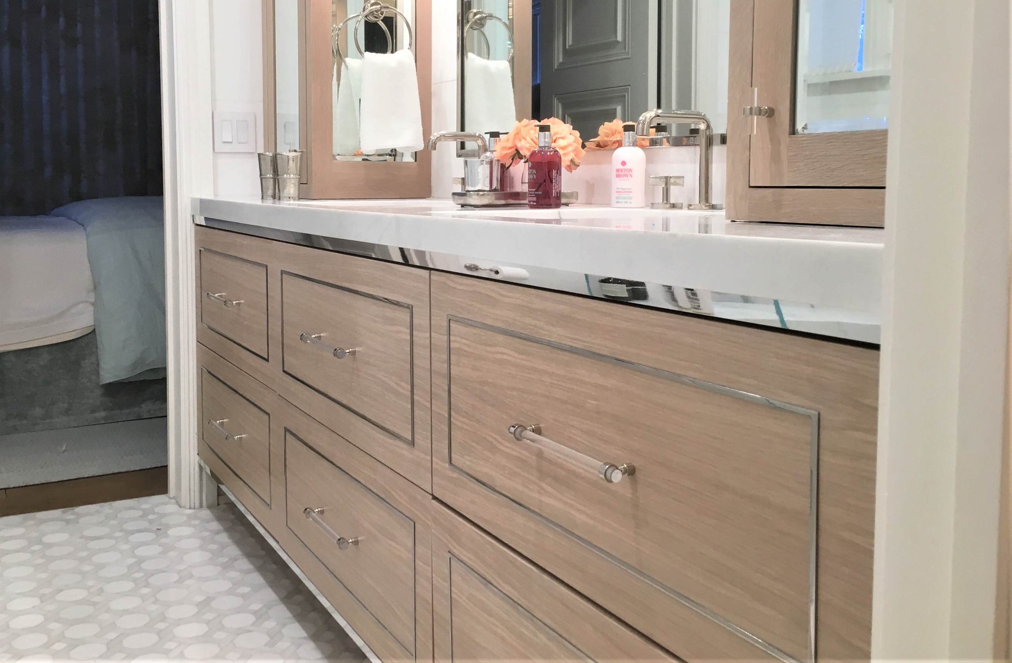 Mid-sized modern master mosaic tile floor and white floor bathroom with flat-panel cabinets, light wood cabinets, white walls, an undermount sink, marble countertops and a hinged shower door, by Jensen Design in Telluride, CO