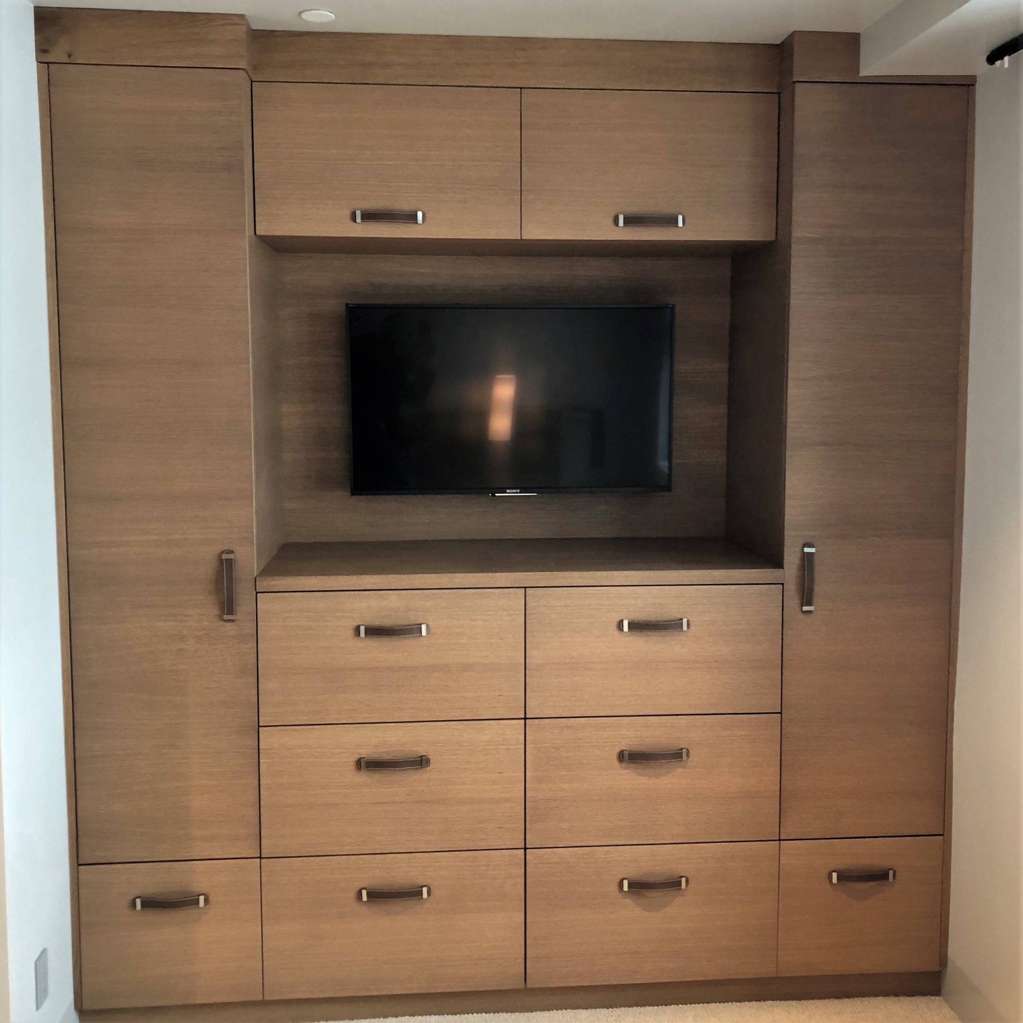Mid-sized contemporary gender-neutral light wood floor walk-in closet with open cabinets and light wood cabinets, by Jensen Design in Mountain Village, CO