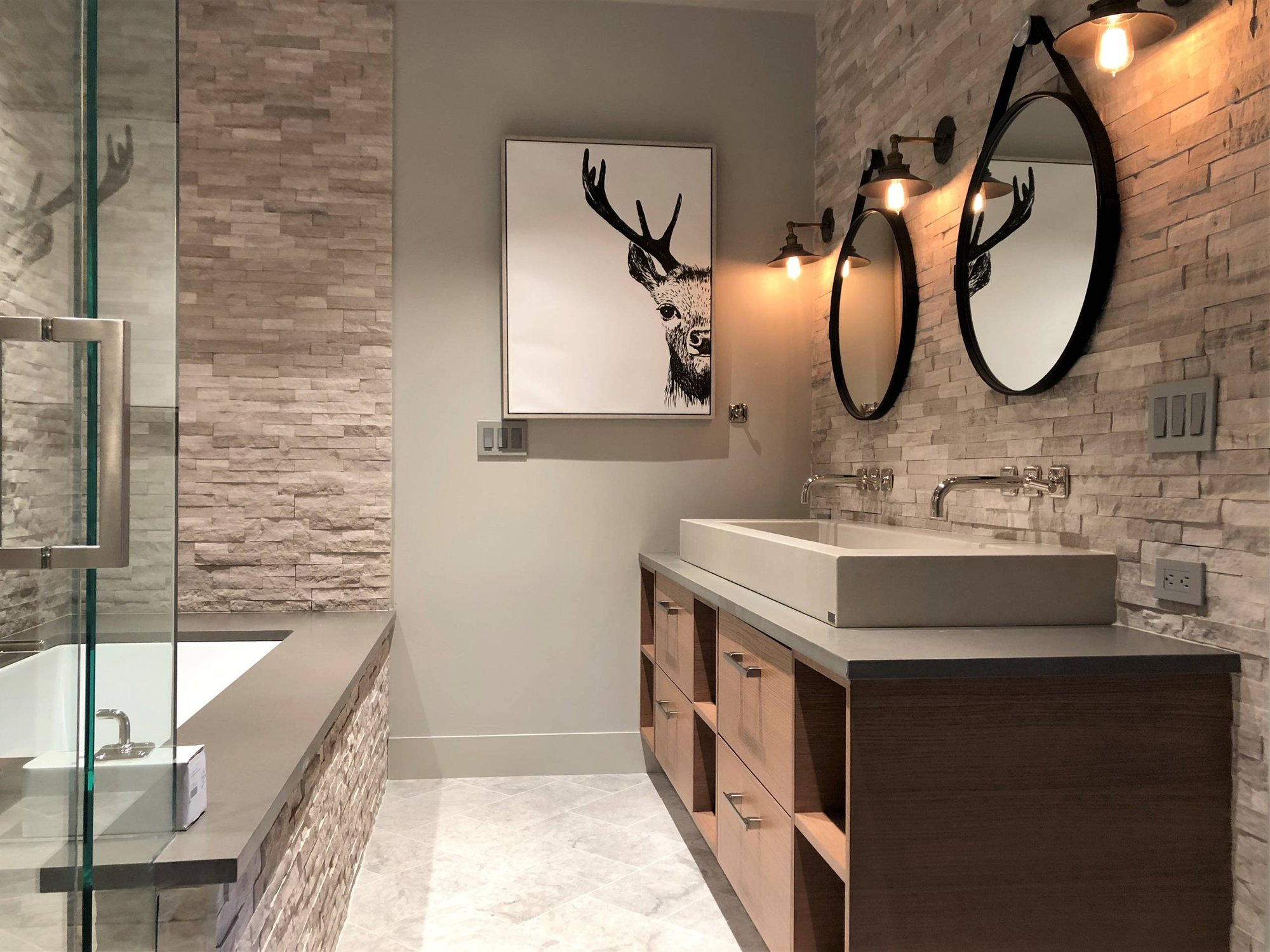 Mid-sized contemporary gray tile and stone tile gray floor and marble floor bathroom with flat-panel cabinets, medium tone wood cabinets, a two-piece toilet, gray walls, a vessel sink, quartzite countertops, a hinged shower door and gray countertops, by Jensen Design in Mountain Village, CO