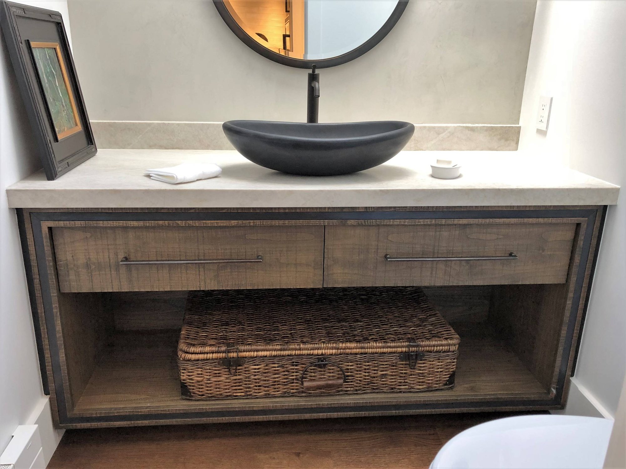 Mid-sized contemporary 3/4 stone slab medium tone wood floor and brown floor bathroom with flat-panel cabinets, distressed cabinets, a two-piece toilet, gray walls, a vessel sink, quartzite countertops and white countertops, by Jensen Design in Telluride, CO