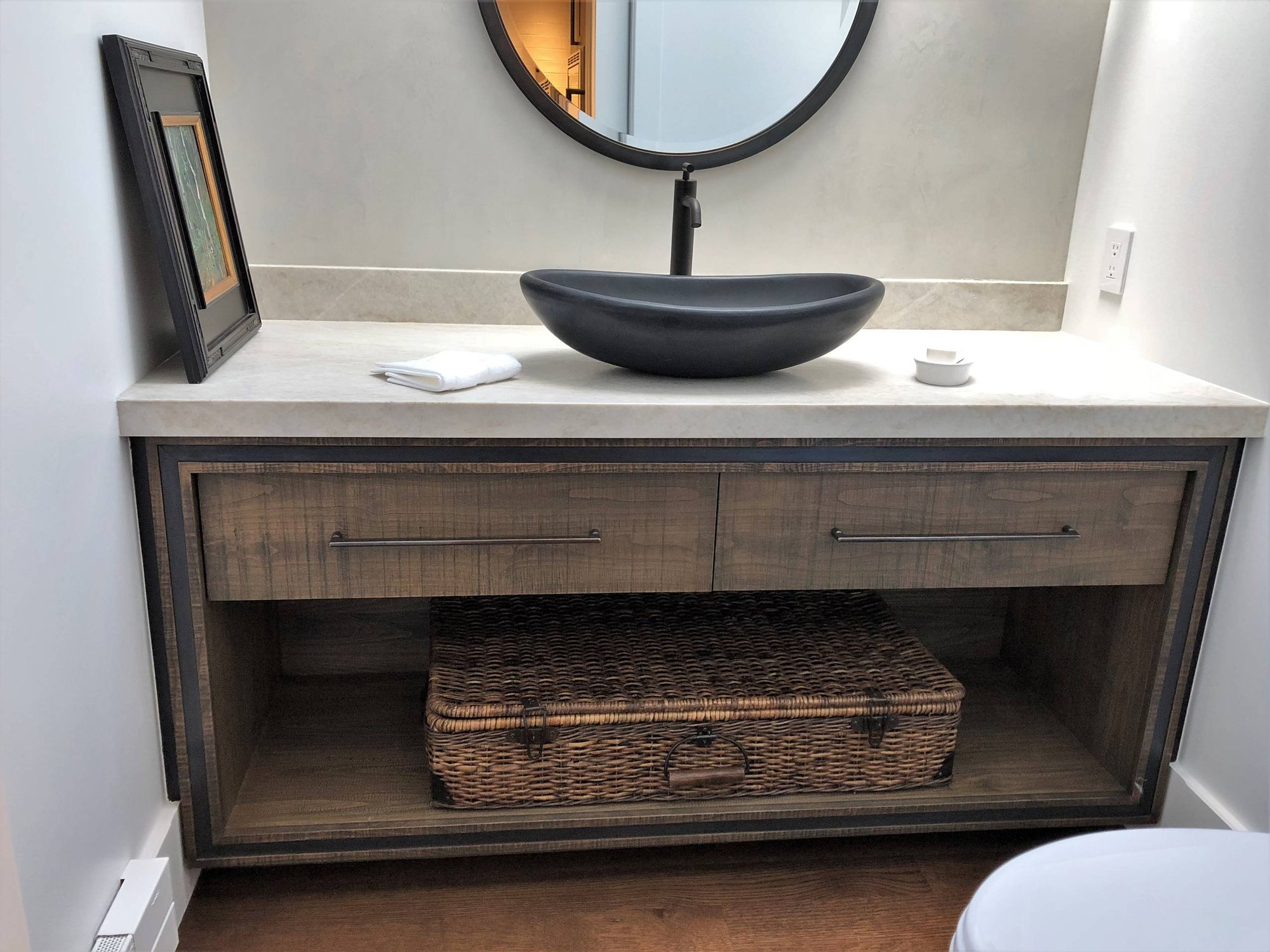 Mid-sized contemporary 3/4 stone slab medium tone wood floor and brown floor bathroom with flat-panel cabinets, distressed cabinets, a two-piece toilet, gray walls, a vessel sink, quartzite countertops and white countertops, by Jensen Design in Telluride, CO