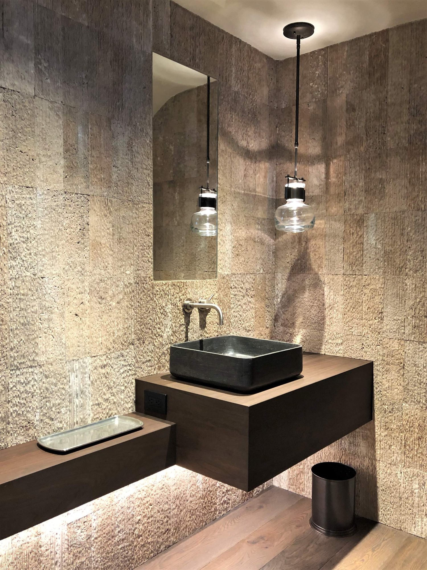 Small trendy 3/4 beige tile medium tone wood floor, brown floor and single-sink bathroom with flat-panel cabinets, dark wood cabinets, beige walls, a vessel sink, wood countertops, brown countertops and a floating vanity, by Jensen Design in Telluride, CO
