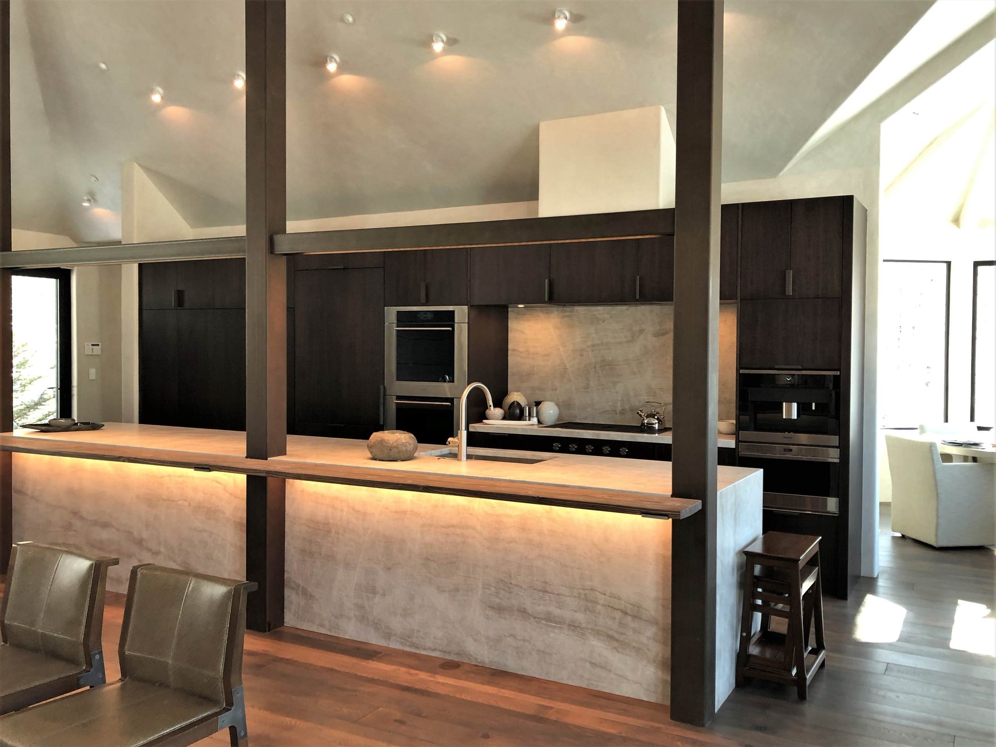 Large contemporary galley medium tone wood floor, brown floor and vaulted ceiling open concept kitchen with an undermount sink, flat-panel cabinets, dark wood cabinets, multicolored backsplash, colored appliances, an island and multicolored countertops, by Jensen Design in Telluride, CO