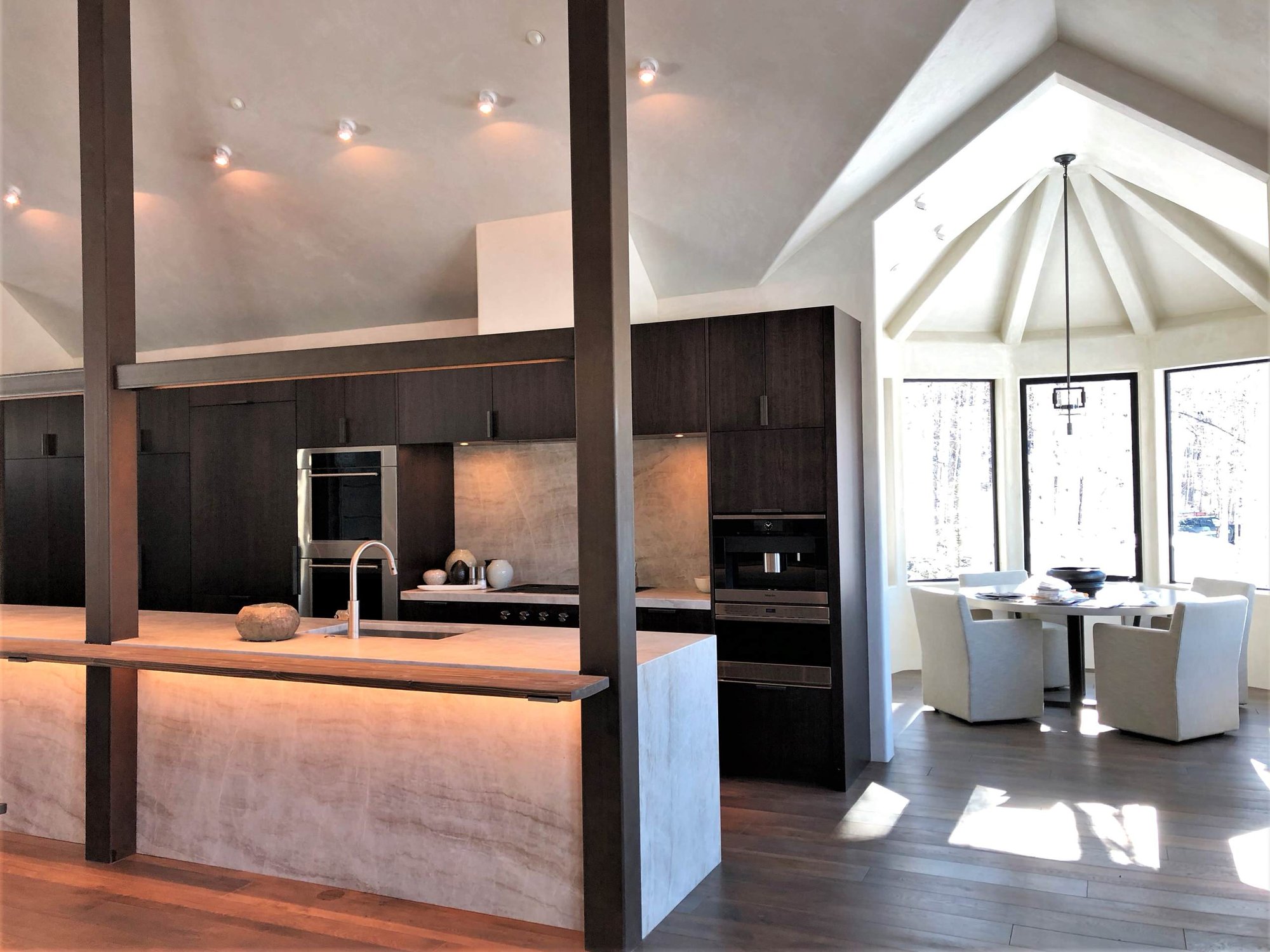 Large contemporary galley medium tone wood floor, brown floor and vaulted ceiling open concept kitchen with an undermount sink, flat-panel cabinets, dark wood cabinets, colored appliances, an island and multicolored countertops, by Jensen Design in Telluride, CO