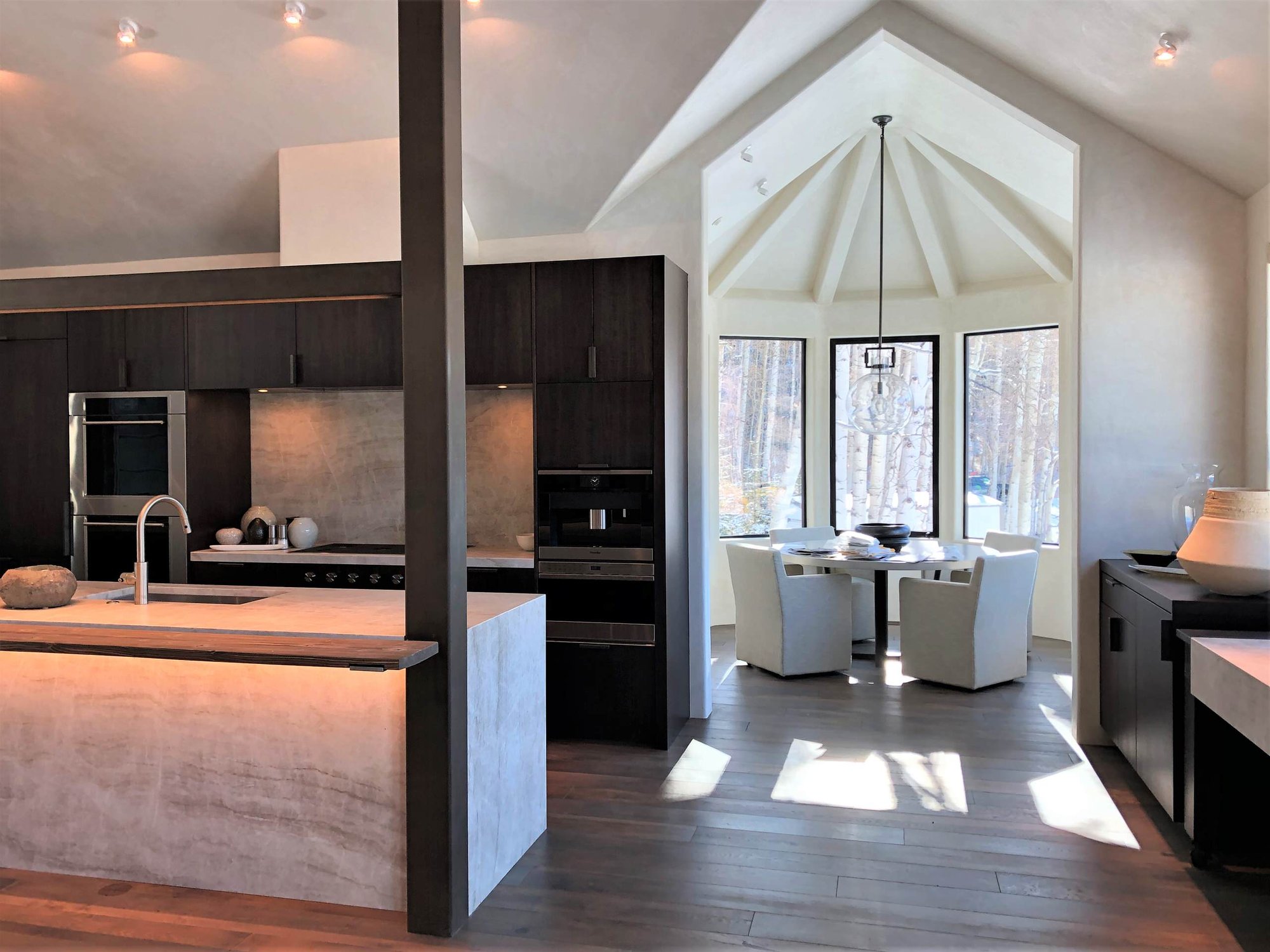 Large contemporary galley medium tone wood floor, brown floor and vaulted ceiling open concept kitchen with an undermount sink, flat-panel cabinets, dark wood cabinets, colored appliances, an island and multicolored countertops, by Jensen Design in Telluride, CO