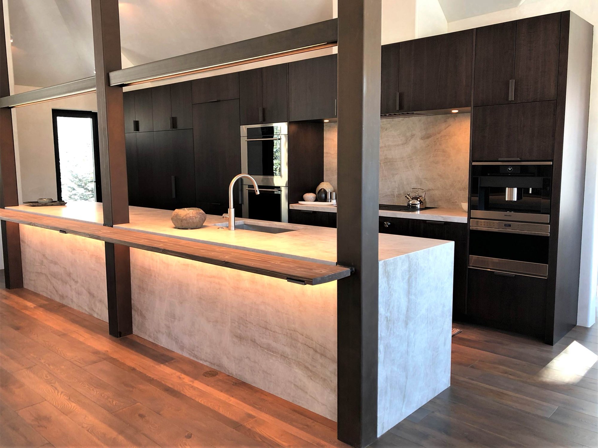 Large contemporary galley medium tone wood floor, brown floor and vaulted ceiling open concept kitchen with an undermount sink, flat-panel cabinets, dark wood cabinets, colored appliances, an island and multicolored countertops, by Jensen Design in Telluride, CO