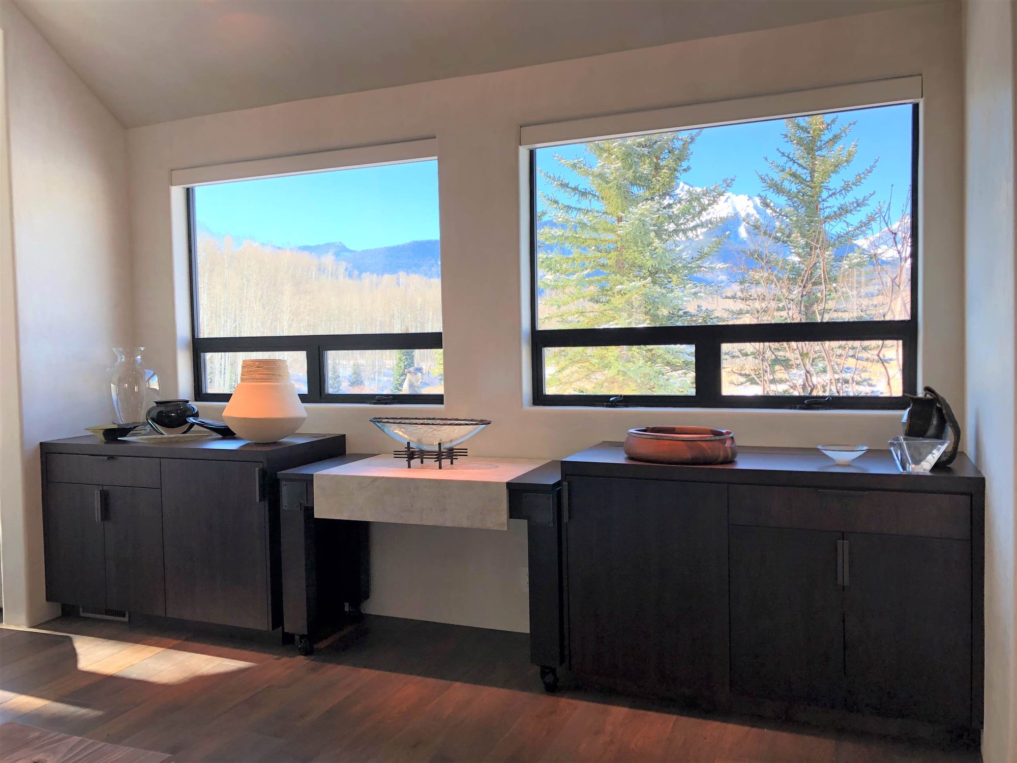 Large contemporary galley medium tone wood floor, brown floor and vaulted ceiling open concept kitchen with an undermount sink, flat-panel cabinets, dark wood cabinets, colored appliances, an island and multicolored countertops, by Jensen Design in Telluride, CO