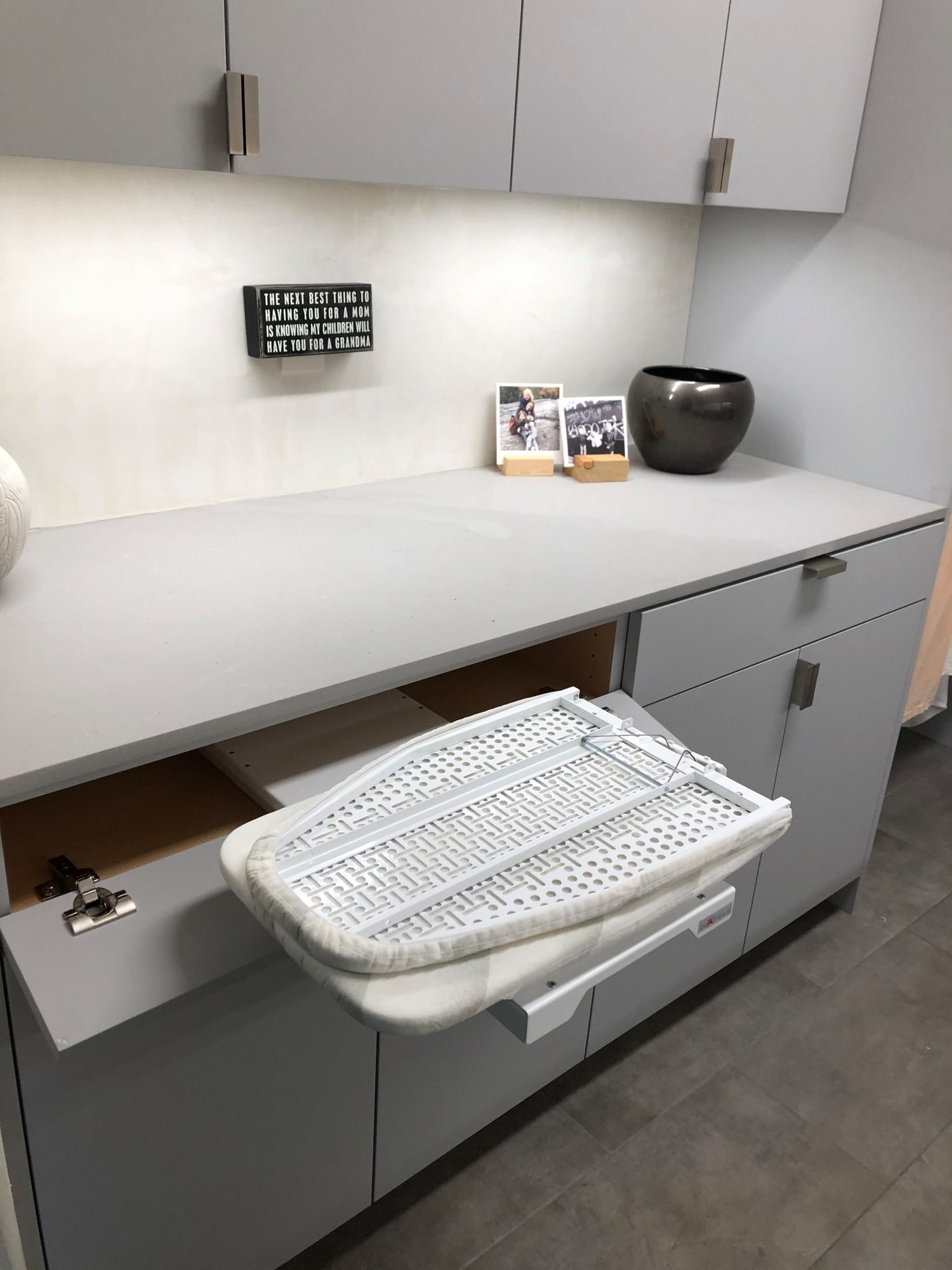 Mid-sized contemporary galley gray floor dedicated laundry room with an undermount sink, flat-panel cabinets, gray cabinets, beige walls, a side-by-side washer/dryer and gray countertops, by Jensen Design in Telluride, CO