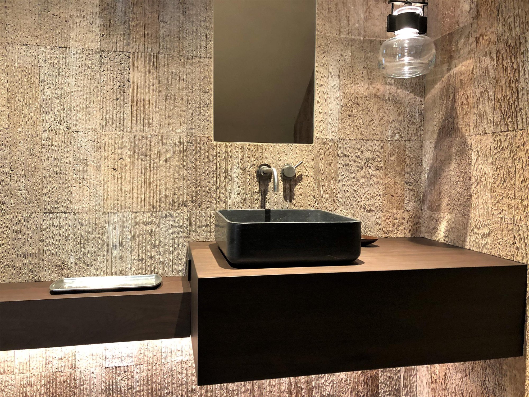 Small trendy 3/4 beige tile medium tone wood floor, brown floor and single-sink bathroom with flat-panel cabinets, dark wood cabinets, beige walls, a vessel sink, wood countertops, brown countertops and a floating vanity, by Jensen Design in Telluride, CO