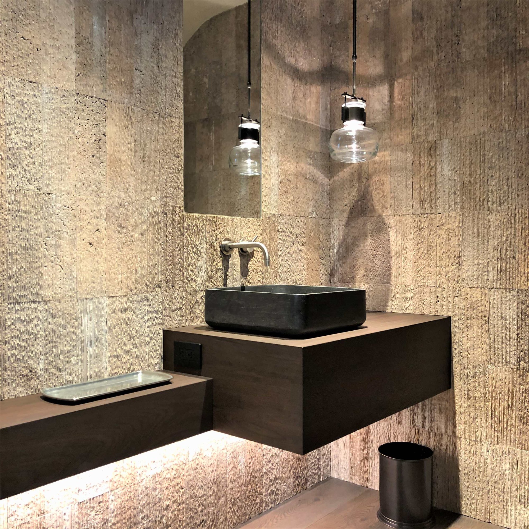 Small contemporary 3/4 beige tile medium tone wood floor, brown floor and single-sink bathroom with flat-panel cabinets, dark wood cabinets, beige walls, a vessel sink, wood countertops, brown countertops and a floating vanity, by Jensen Design in Telluride, CO