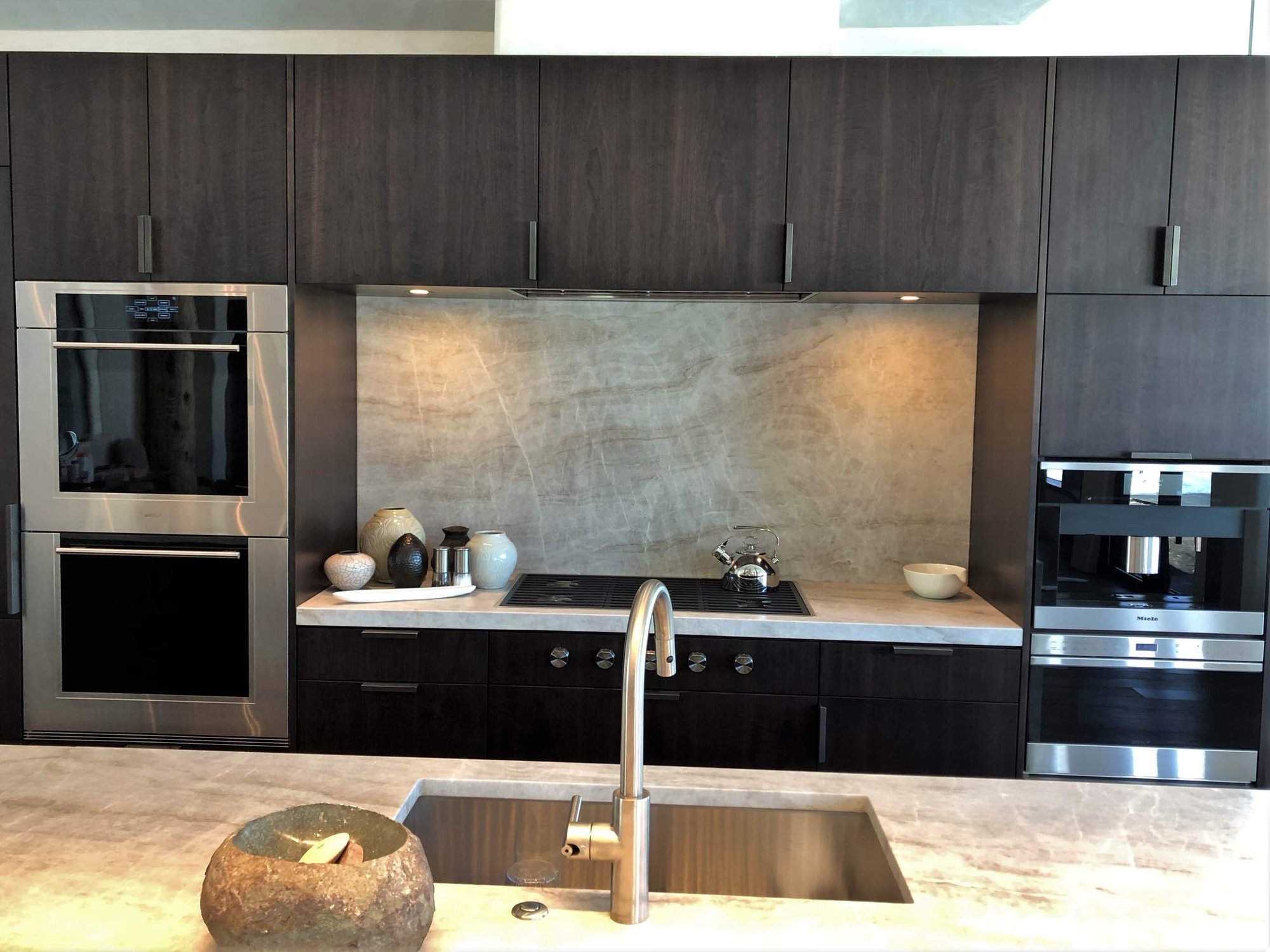Large contemporary galley medium tone wood floor, brown floor and vaulted ceiling open concept kitchen with an undermount sink, flat-panel cabinets, dark wood cabinets, colored appliances, an island and multicolored countertops, by Jensen Design in Telluride, CO